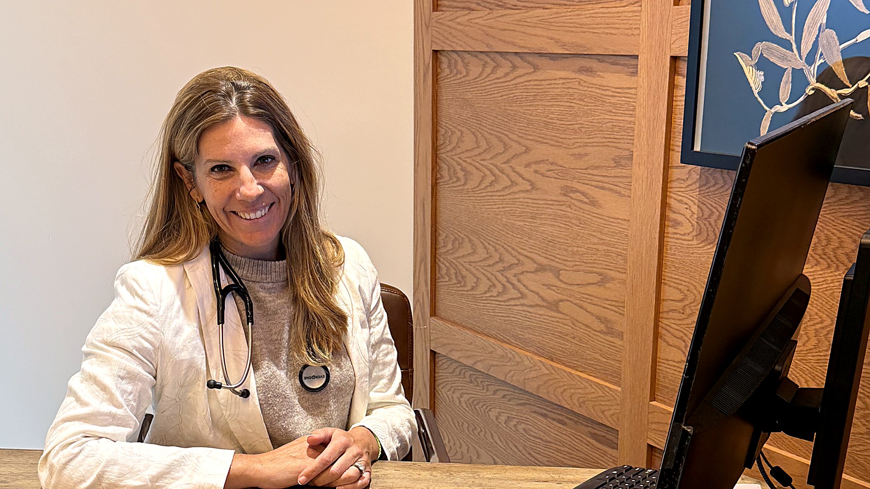 A Materna Health clinician reviewing a patient plan at a desk in the West Village office
