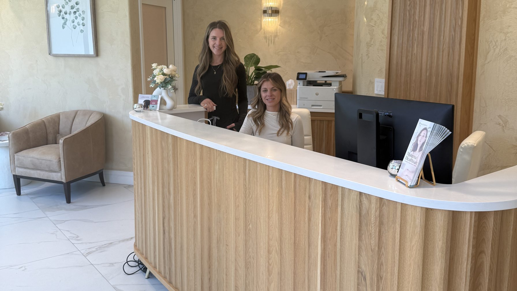 Two Materna Health team members at the front desk of the West Village office