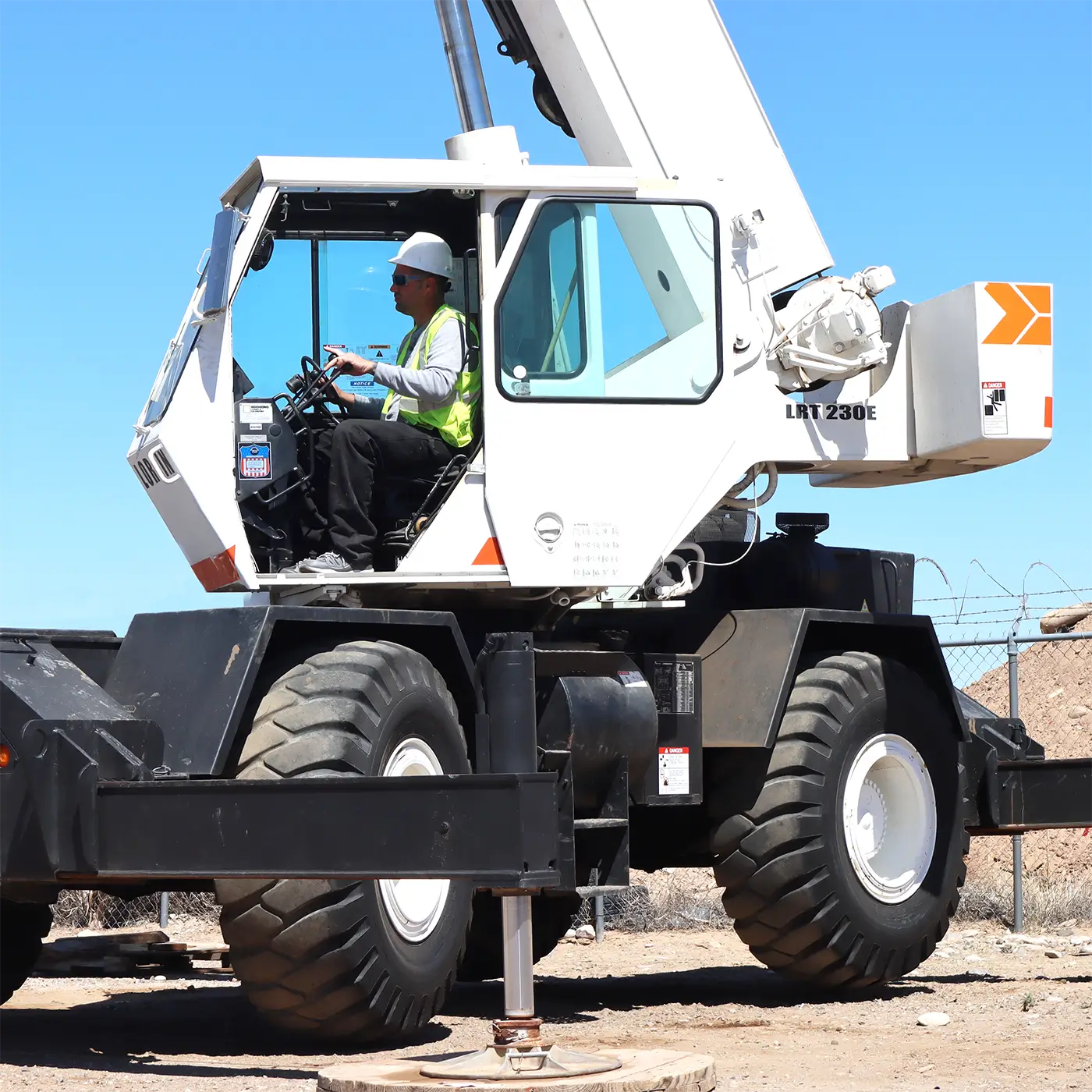 Student operating a mobile crane during practical certification training session.