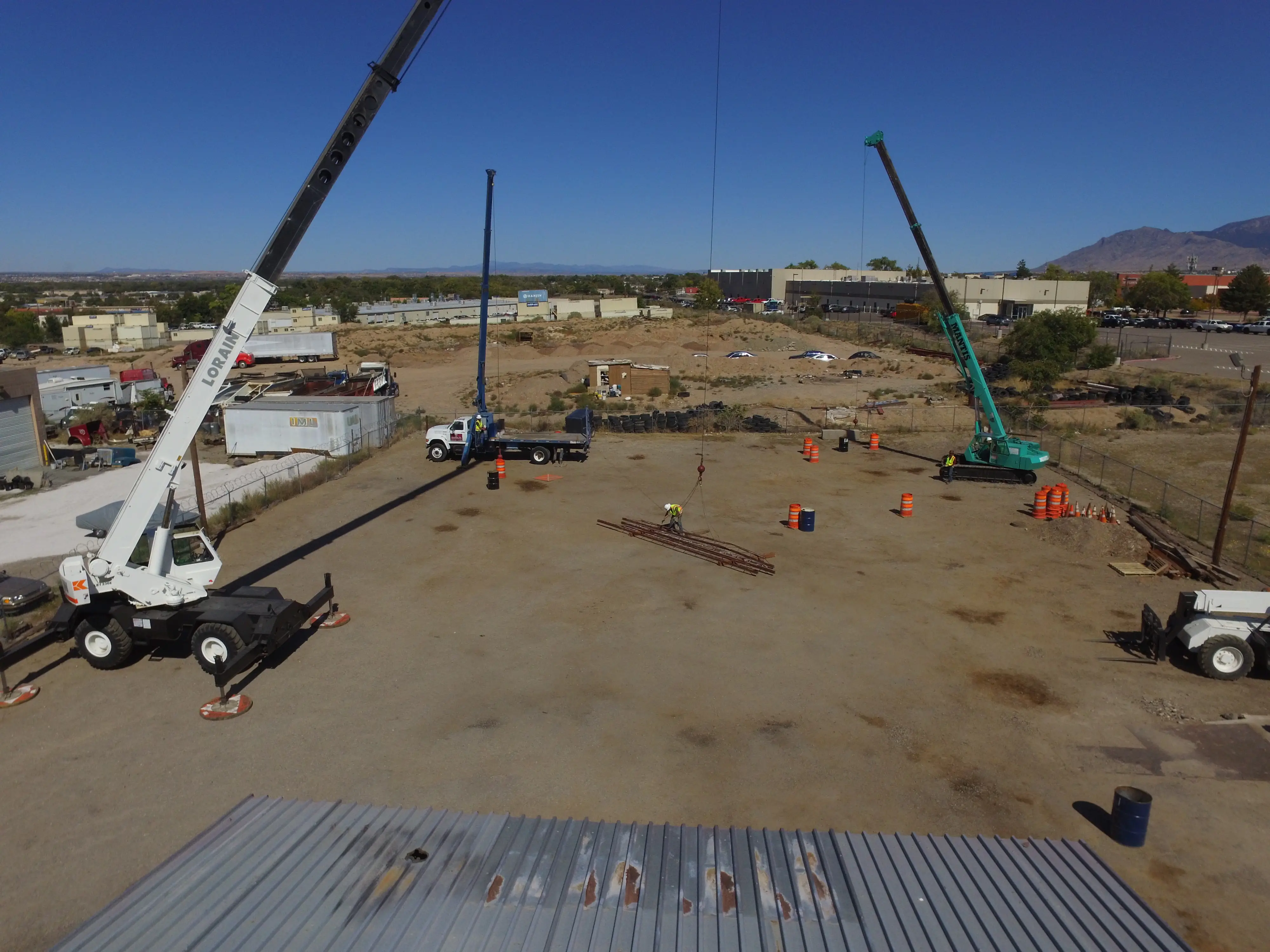 Multiple cranes set up at an outdoor training yard for hands-on crane operator certification program.