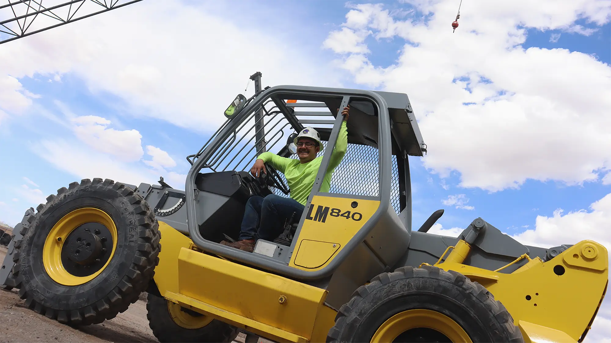 Crane operator trainee inside cab practicing safe equipment operation during basic crane and rigging training.