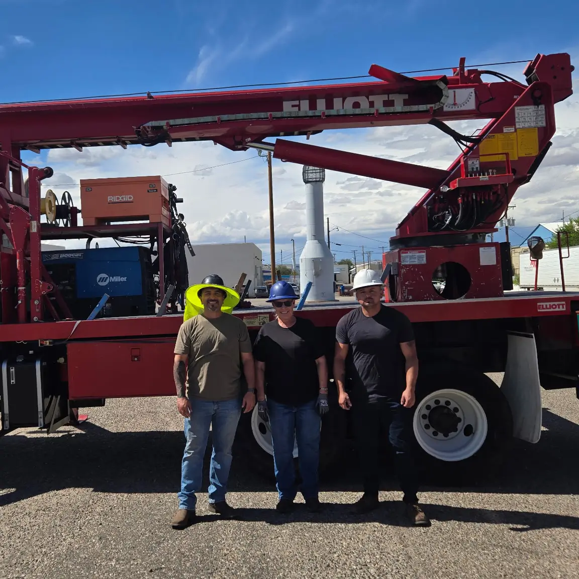 Group of students standing in front of a red truck-mounted crane during national crane operator certification training in Albuquerque.