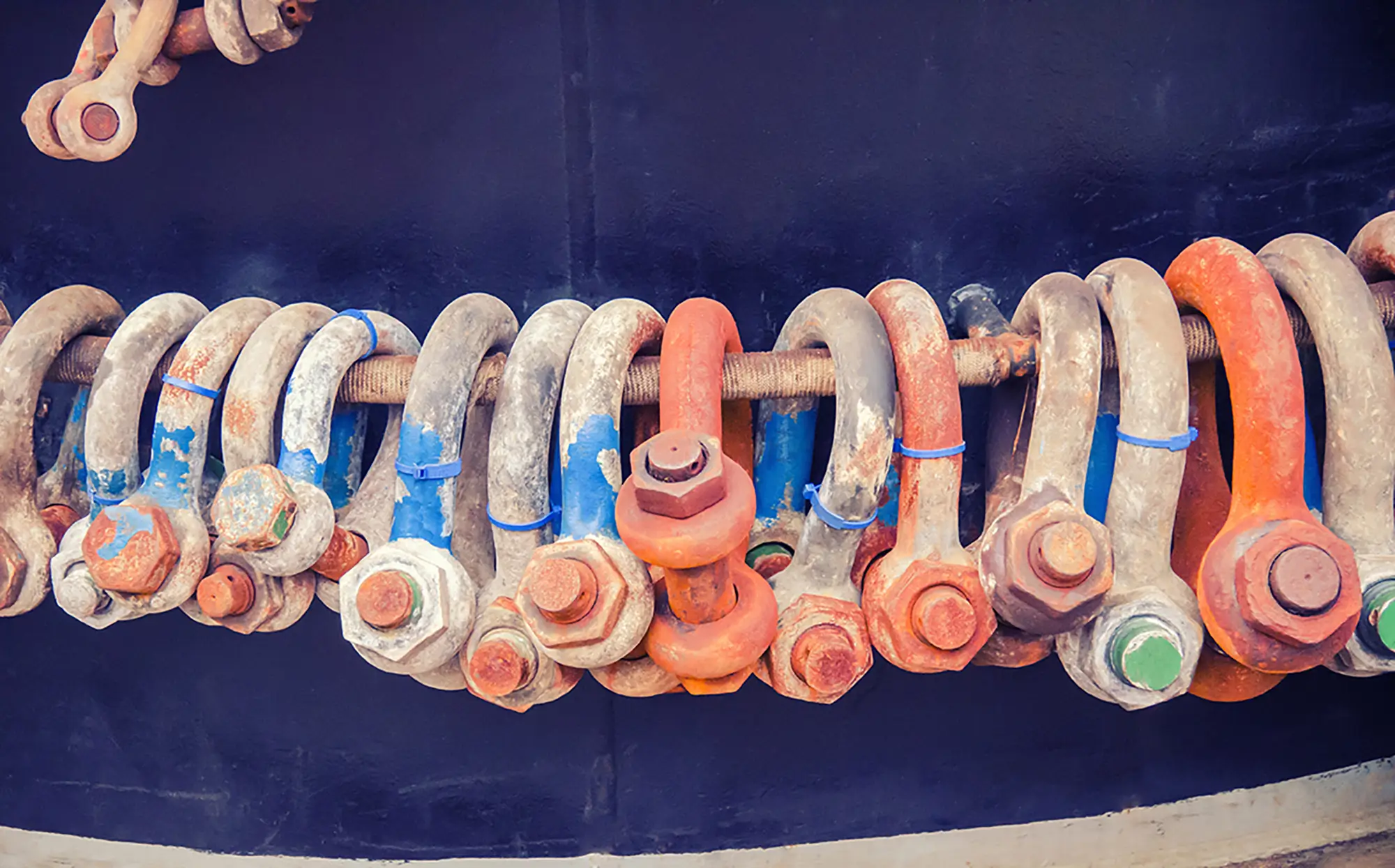 Close-up of industrial rigging shackles and lifting hardware used in qualified rigger training.