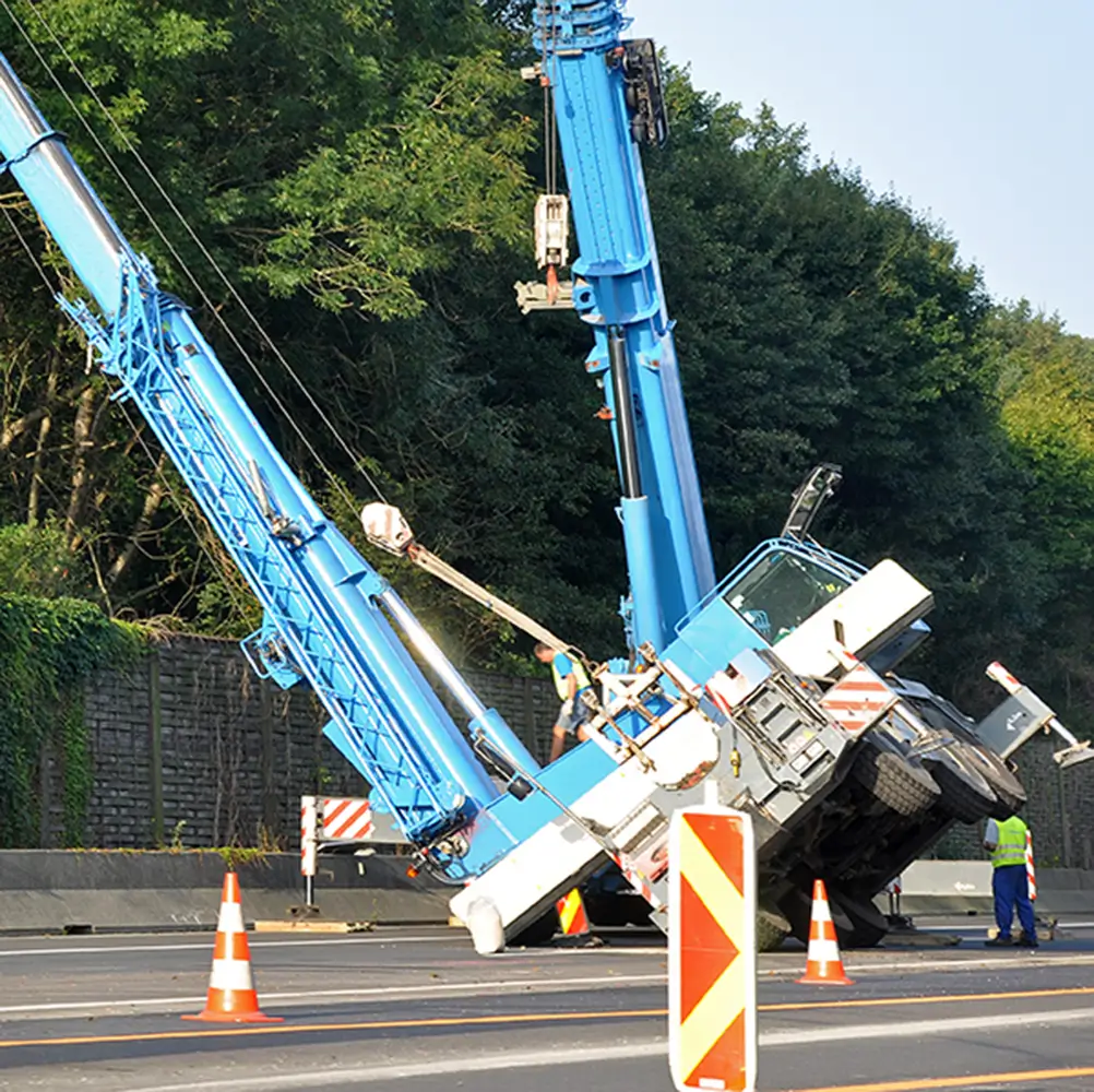 Mobile crane tipped over during lift operation, used for accident investigation and recovery training reference