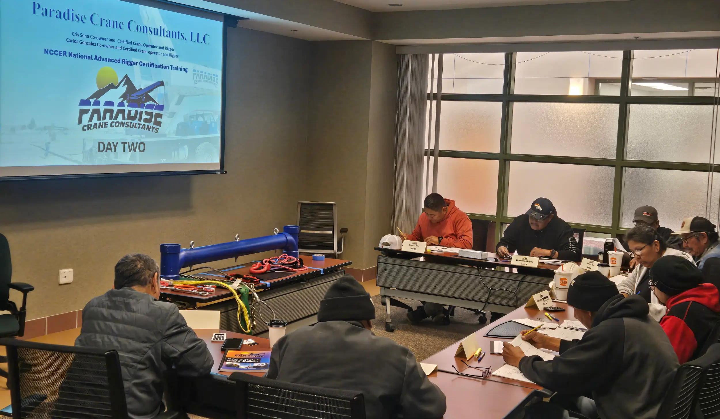 Students attending a crane training classroom session with Paradise Crane Consultants, reviewing rigging and safety procedures