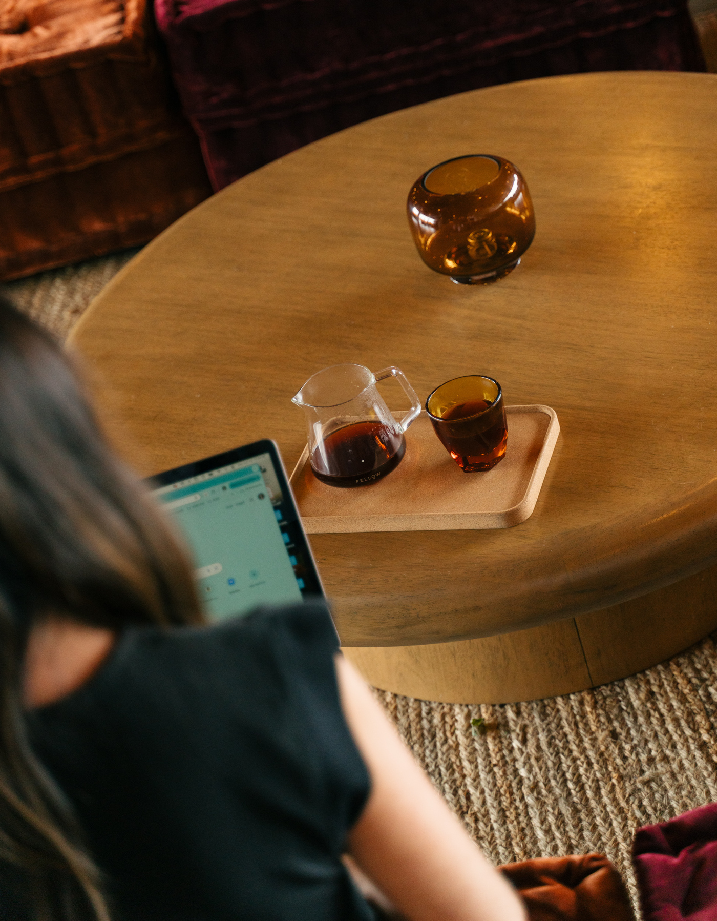 Woman working on laptop at cozy cafe with pour-over coffee on wooden table