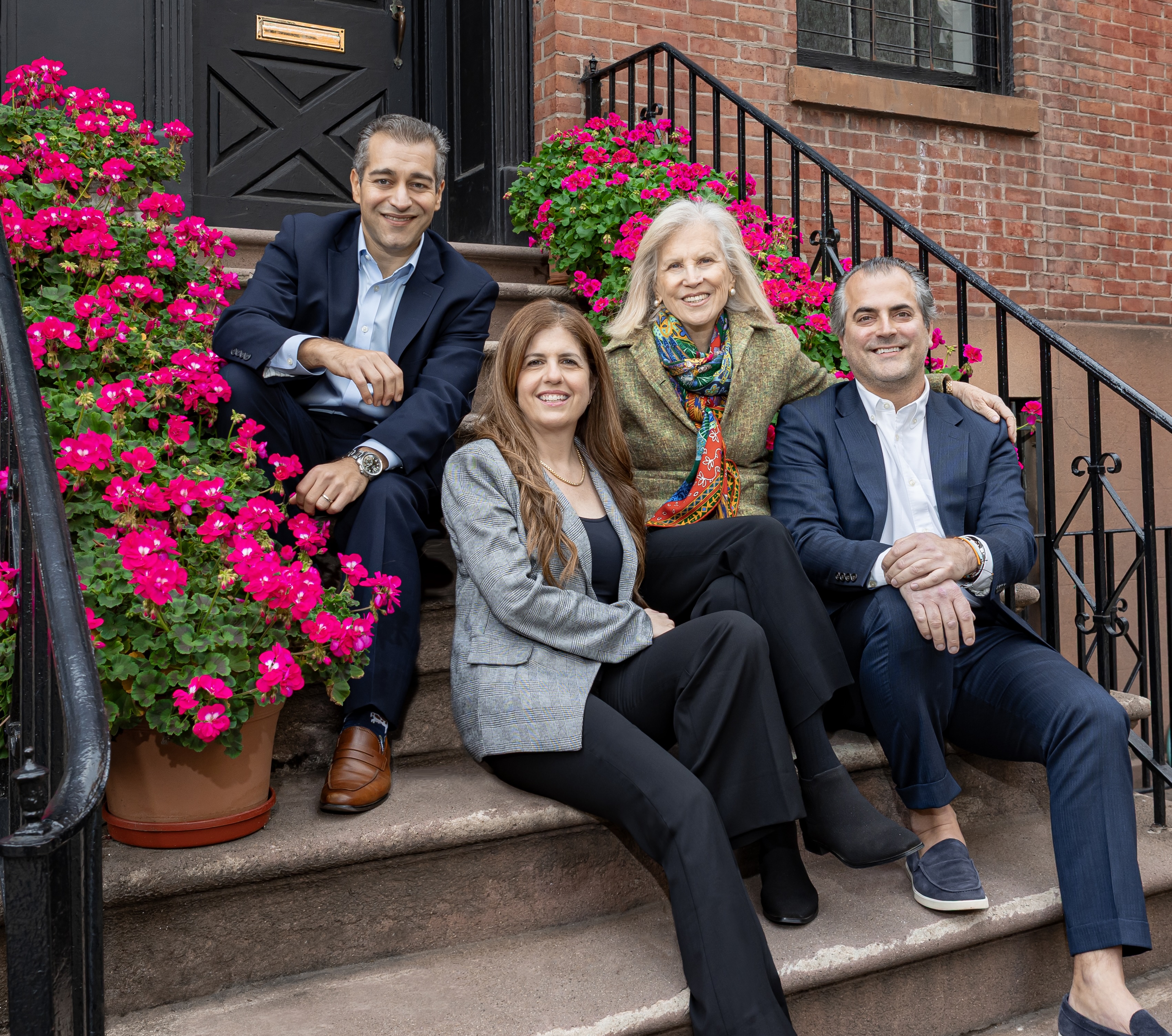 Senior partners and Regina Skyer, founder of special education law firm Skyer Law, sit smiling on a stoop near their Brooklyn office.