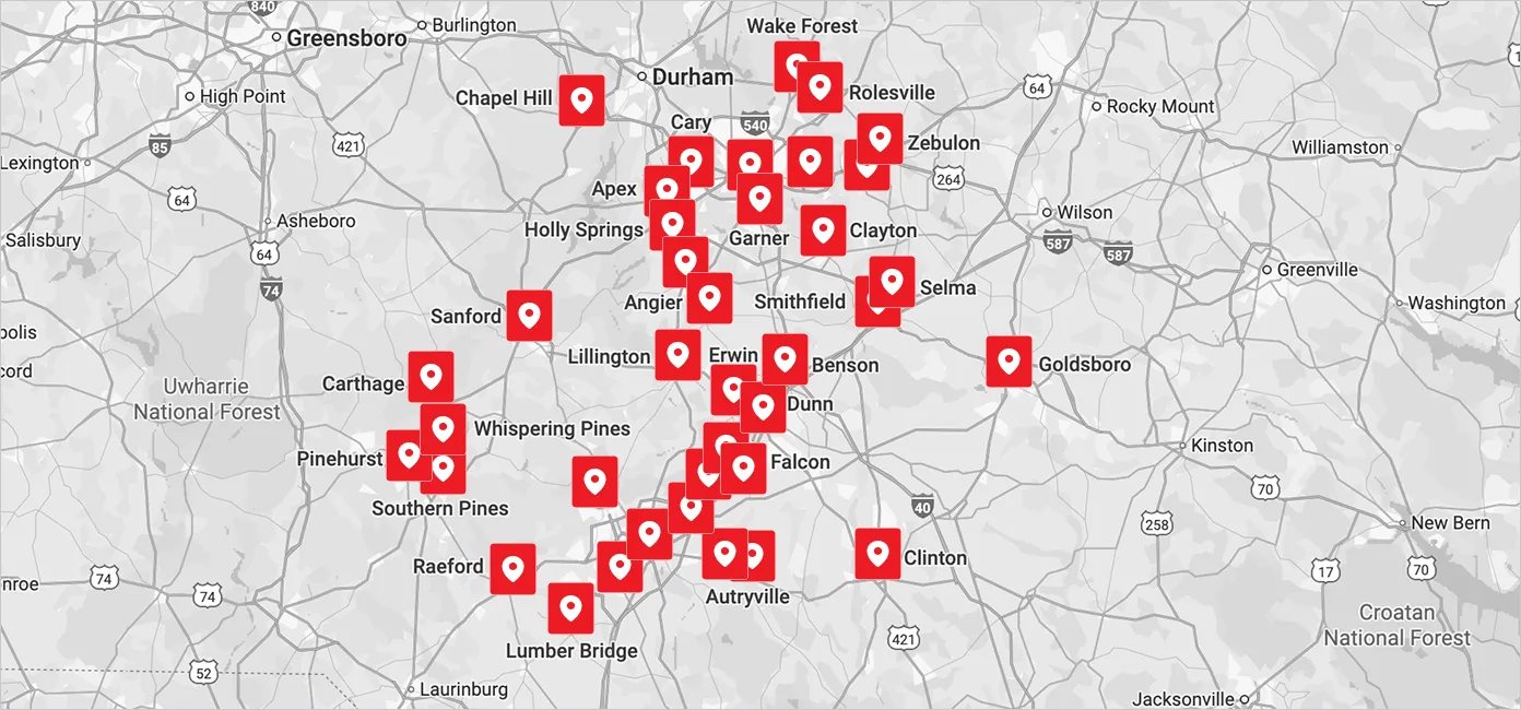Map of central and eastern North Carolina showing cities including Greensboro, Durham, Chapel Hill, Cary, Goldsboro, and Southern Pines with multiple red location markers scattered primarily around Raleigh and Fayetteville areas.