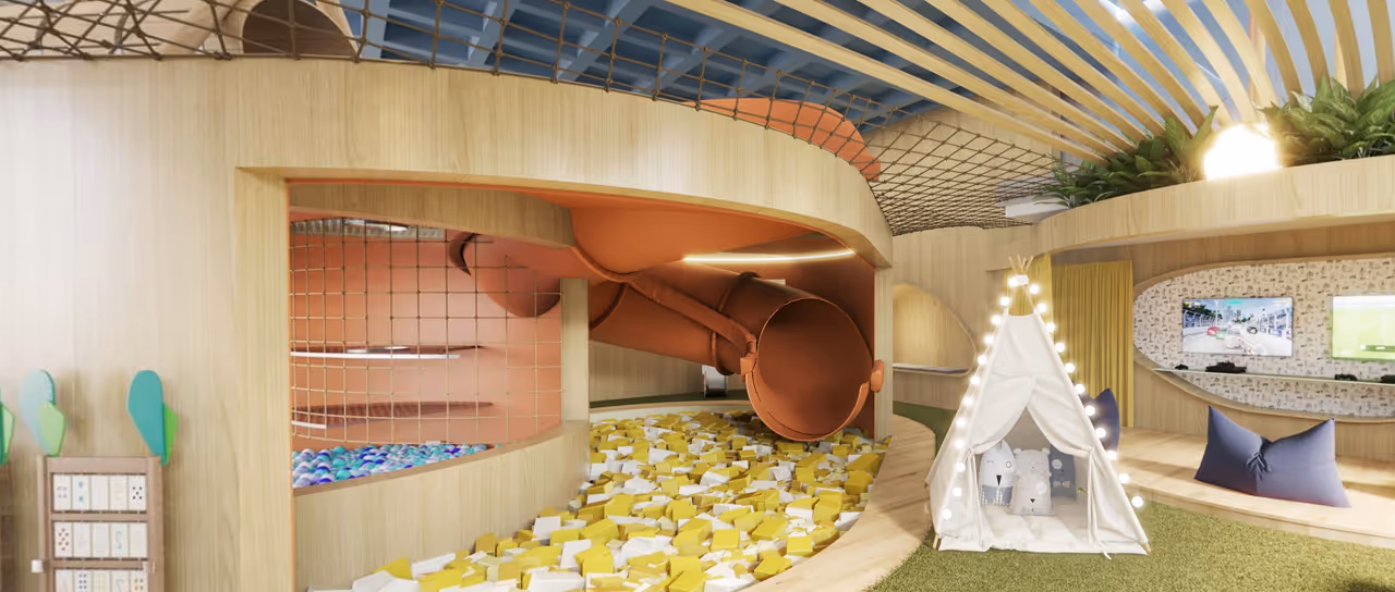 Sala infantil moderna com tobogã laranja que desemboca em piscina de bolinhas amarelas e brancas, tenda branca iluminada e área de jogos com televisores.