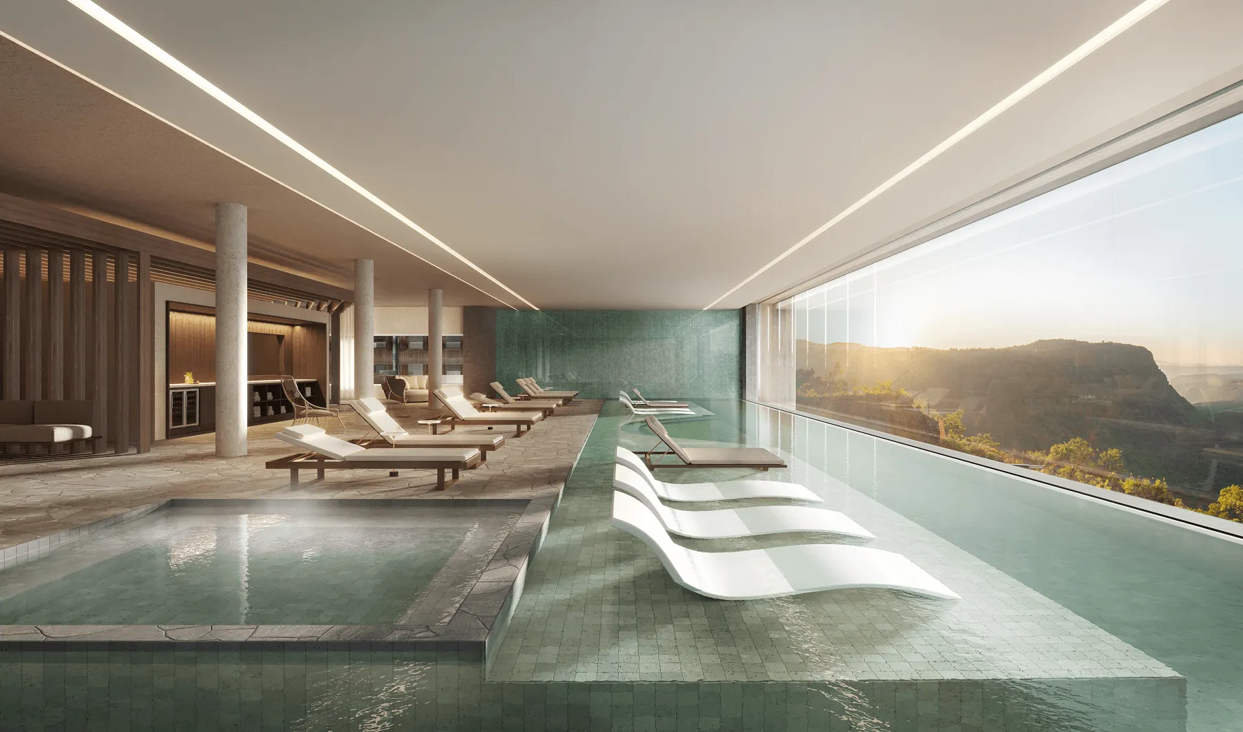 Piscina interna moderna com espreguiçadeiras submersas, área de banheira de hidromassagem e ampla janela com vista para montanhas ao pôr do sol.