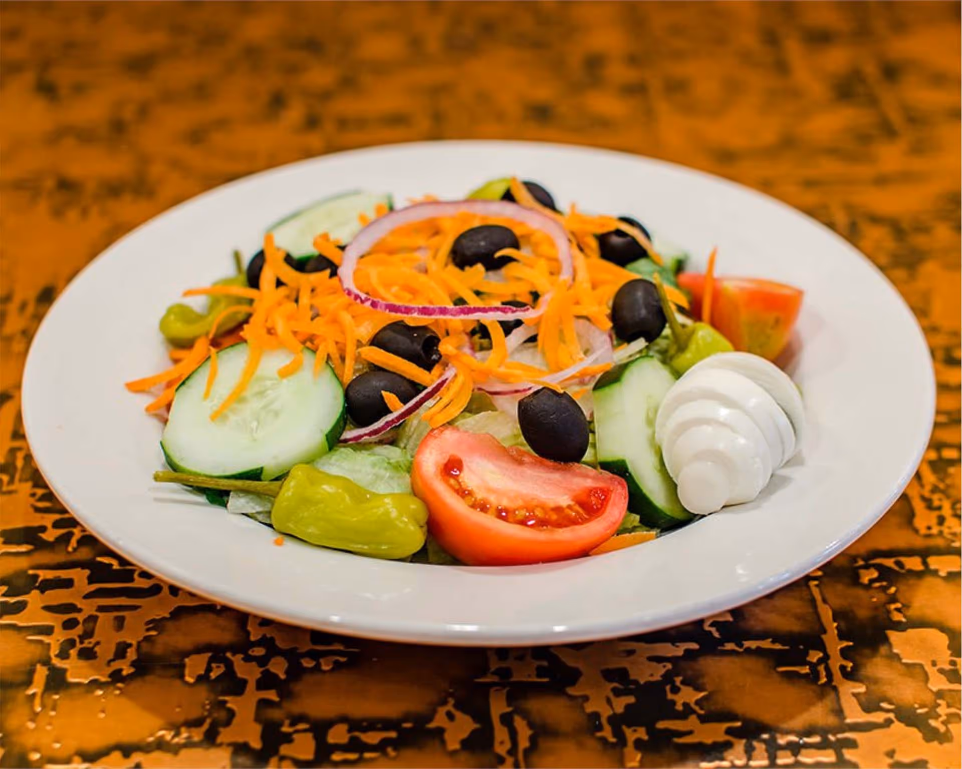 A white plate with a salad on it.