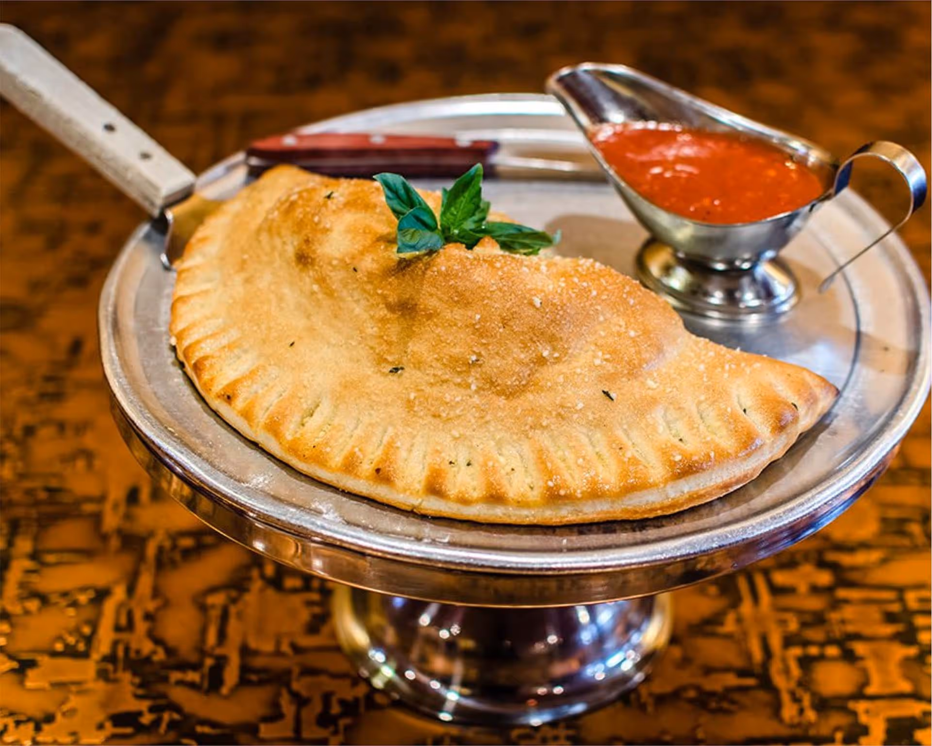 A silver platter with a pizza on it.