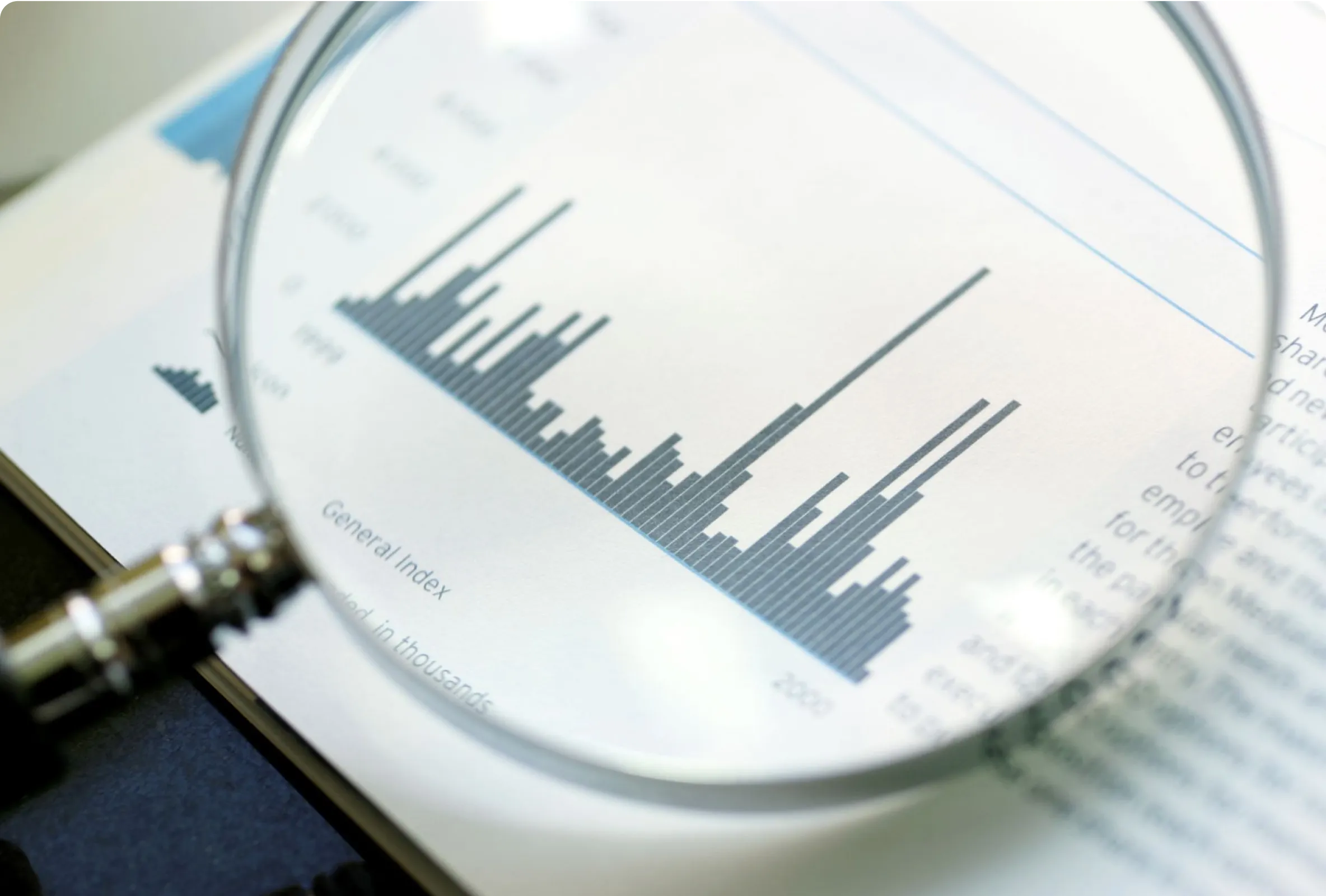 A magnifying glass over bar graphs