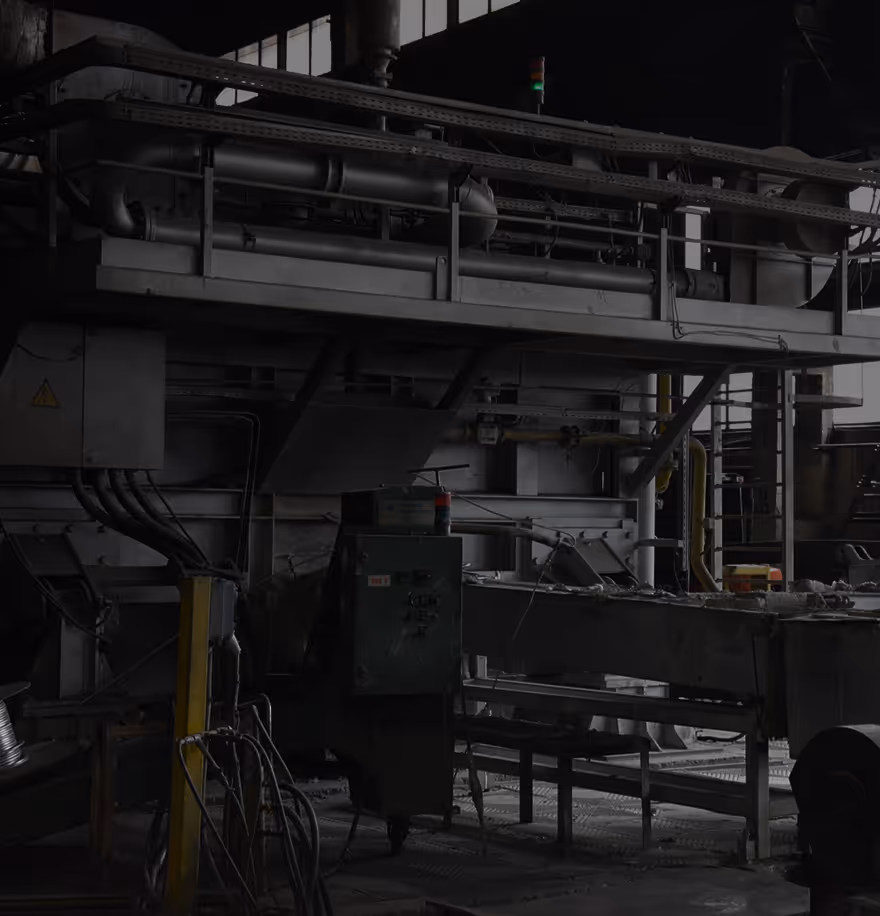 Industrial machinery setup with pipes, cables, and control panels.