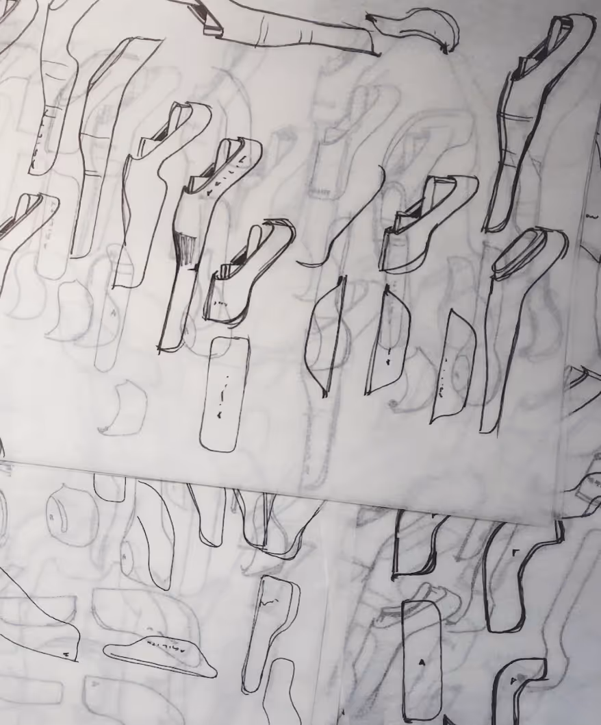 Close-up of a mechanical assembly featuring green and blue metal pulleys connected by steel cables.