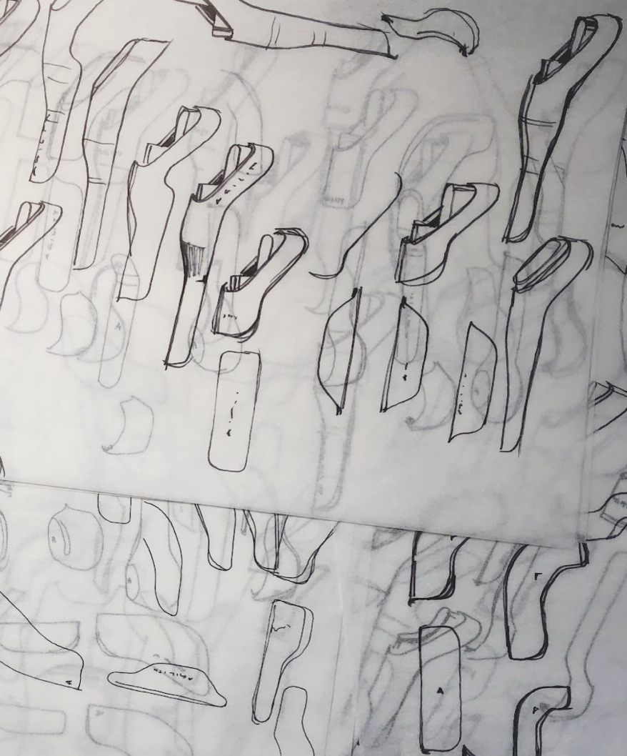 Close-up of a mechanical assembly featuring green and blue metal pulleys connected by steel cables.