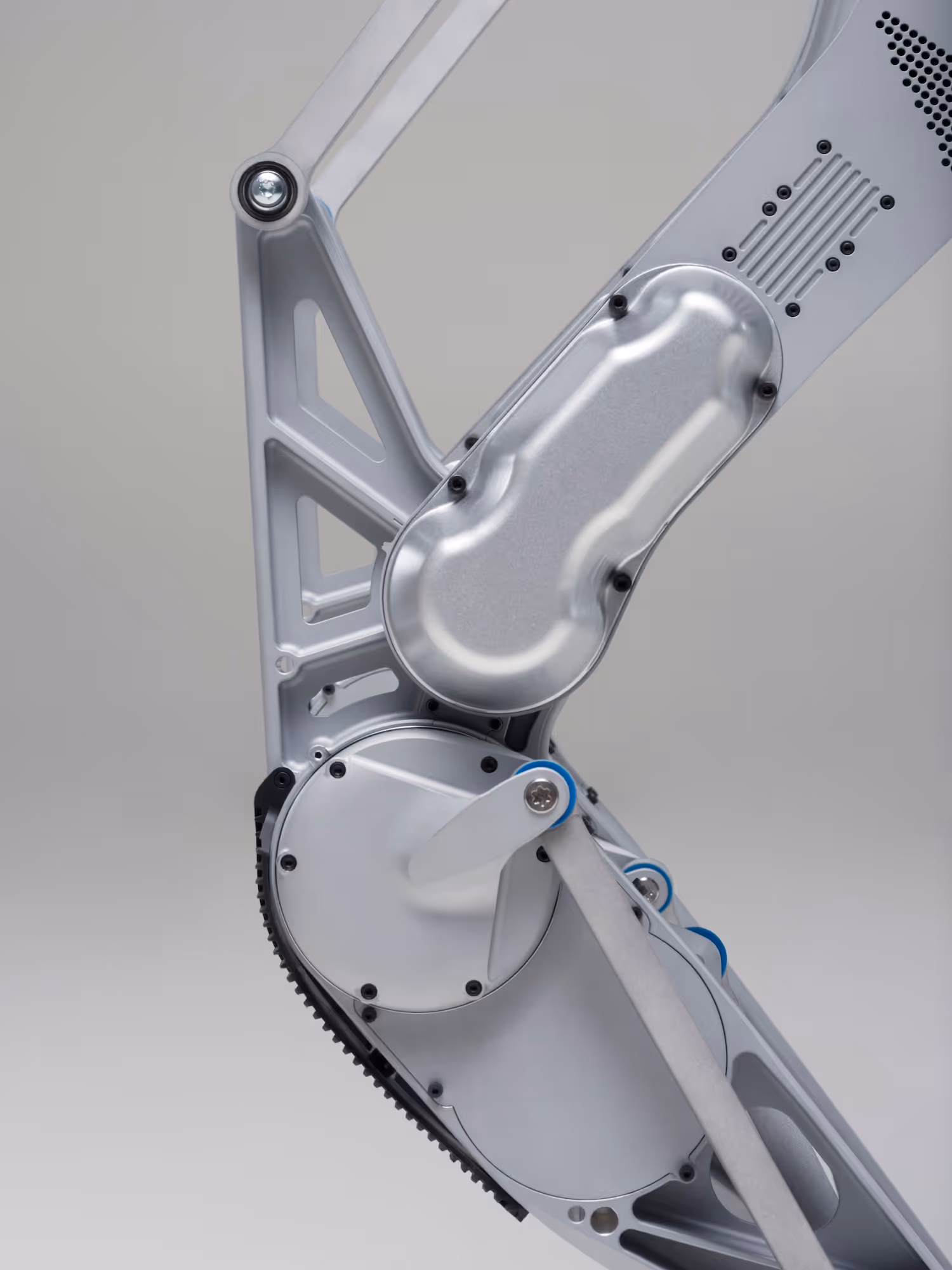 Close-up of a metallic robotic arm joint with visible screws and mechanical parts.