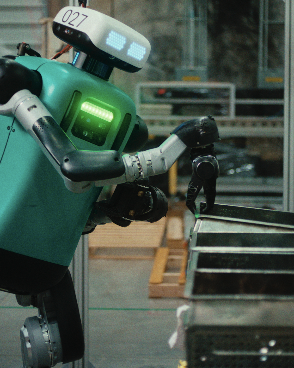 Robot with digital eyes and green chest light using mechanical hand to interact with stacked metal trays.