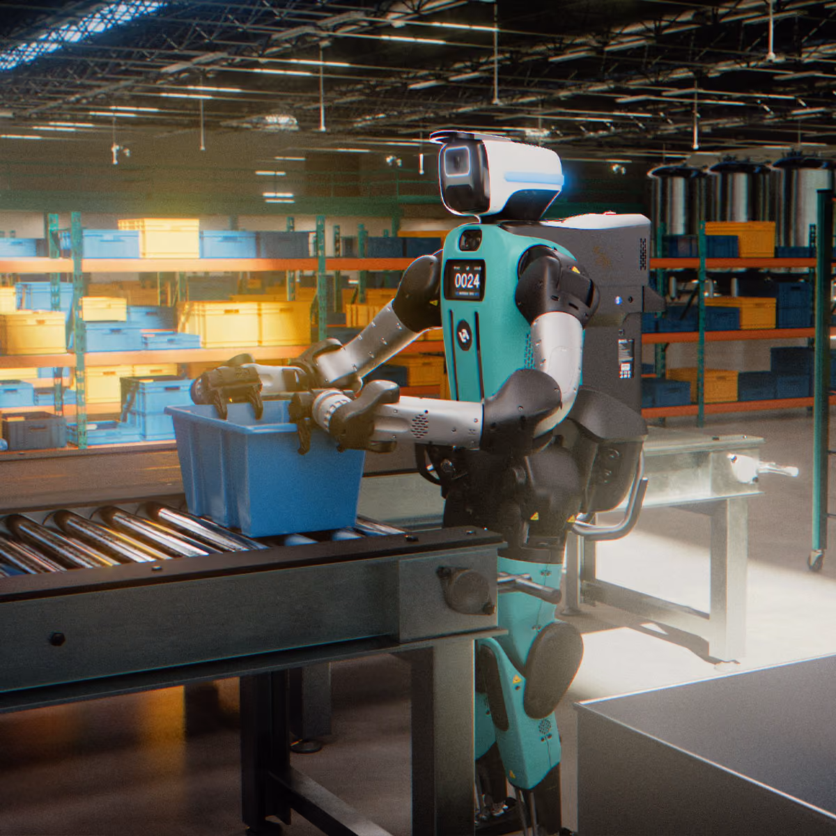 Robot with a teal and silver body operating in a warehouse, placing a blue plastic tote on a conveyor belt surrounded by shelves with stacked blue and yellow bins.