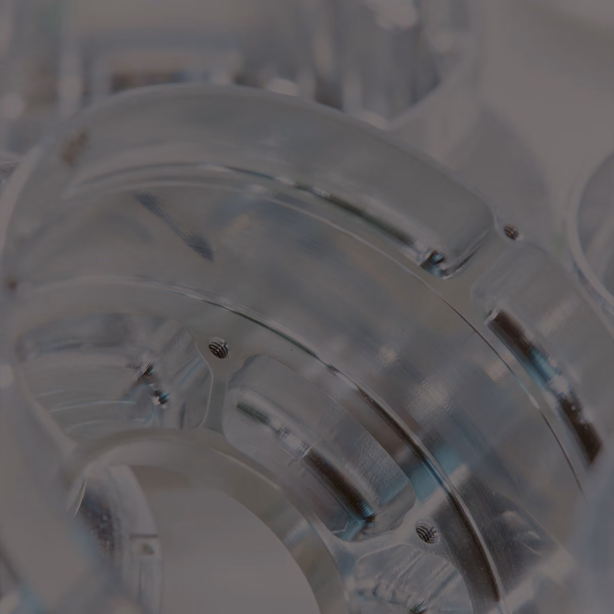 Close-up view of several transparent, circular components with ridged edges stacked together.