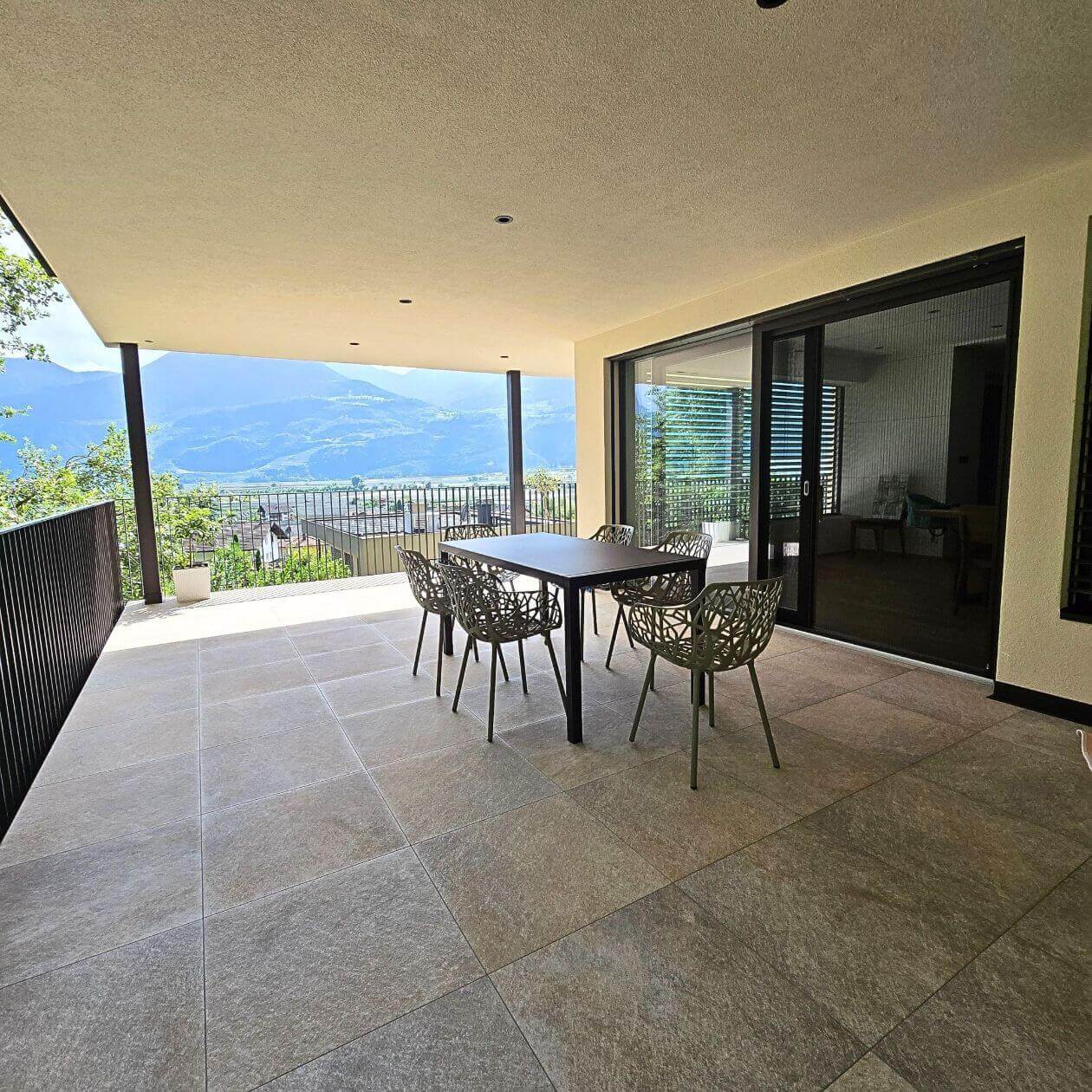 Überdachter Balkon mit Fliesenboden und Bergpanorama
