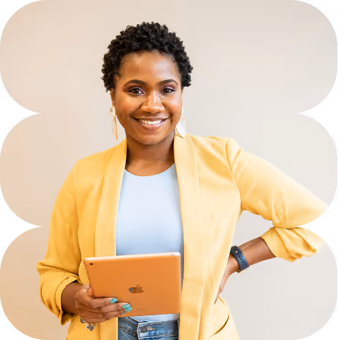 Smiling woman in yellow blazer holding an Apple iPad against a neutral background.