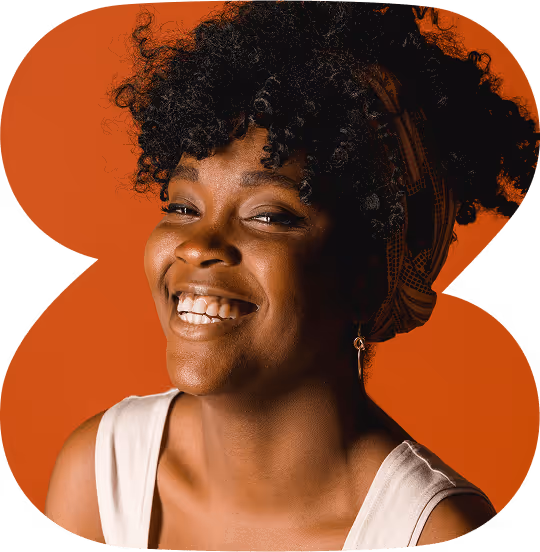 Smiling Black woman with curly hair and headscarf against a green and orange abstract background.