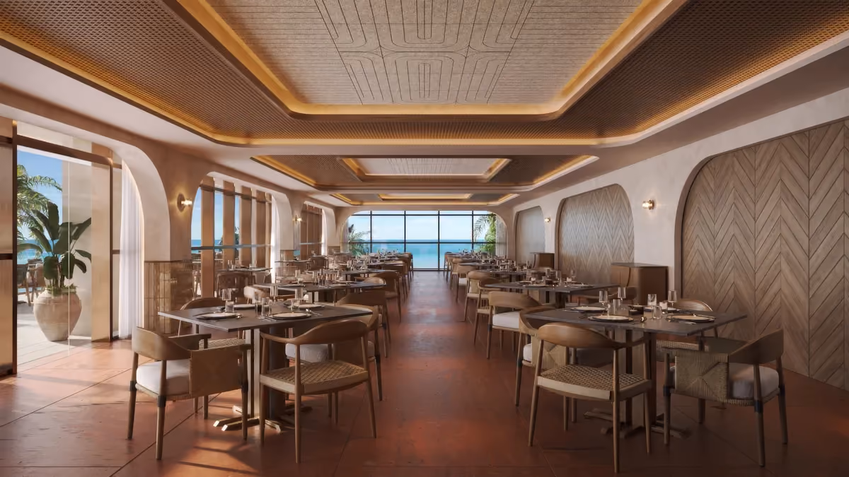 Modern restaurant interior with warm wood accents, multiple tables set with plates and glassware, cushioned chairs, large arched windows, and a view of the ocean in the background.