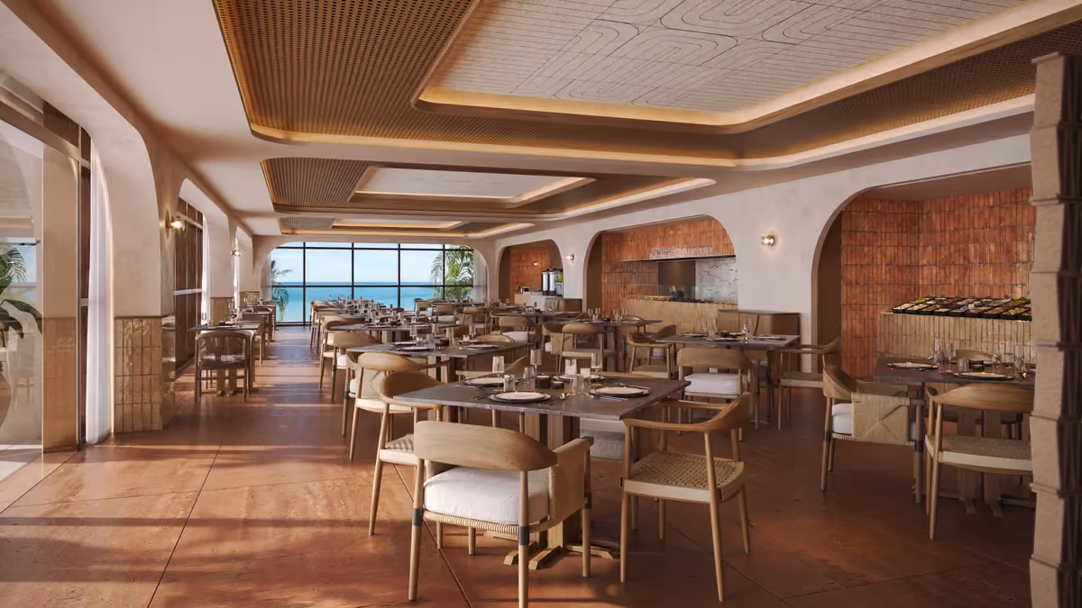 Modern restaurant interior with wooden tables and chairs arranged neatly, large windows at the back showing a view of the ocean, warm lighting, and a decorative ceiling design.