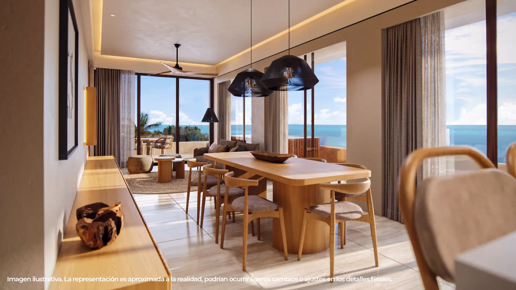 Modern dining and living area with a wooden dining table surrounded by six chairs, two black pendant lights overhead, a lounge area with sofa, coffee tables, and large windows showing an ocean view.