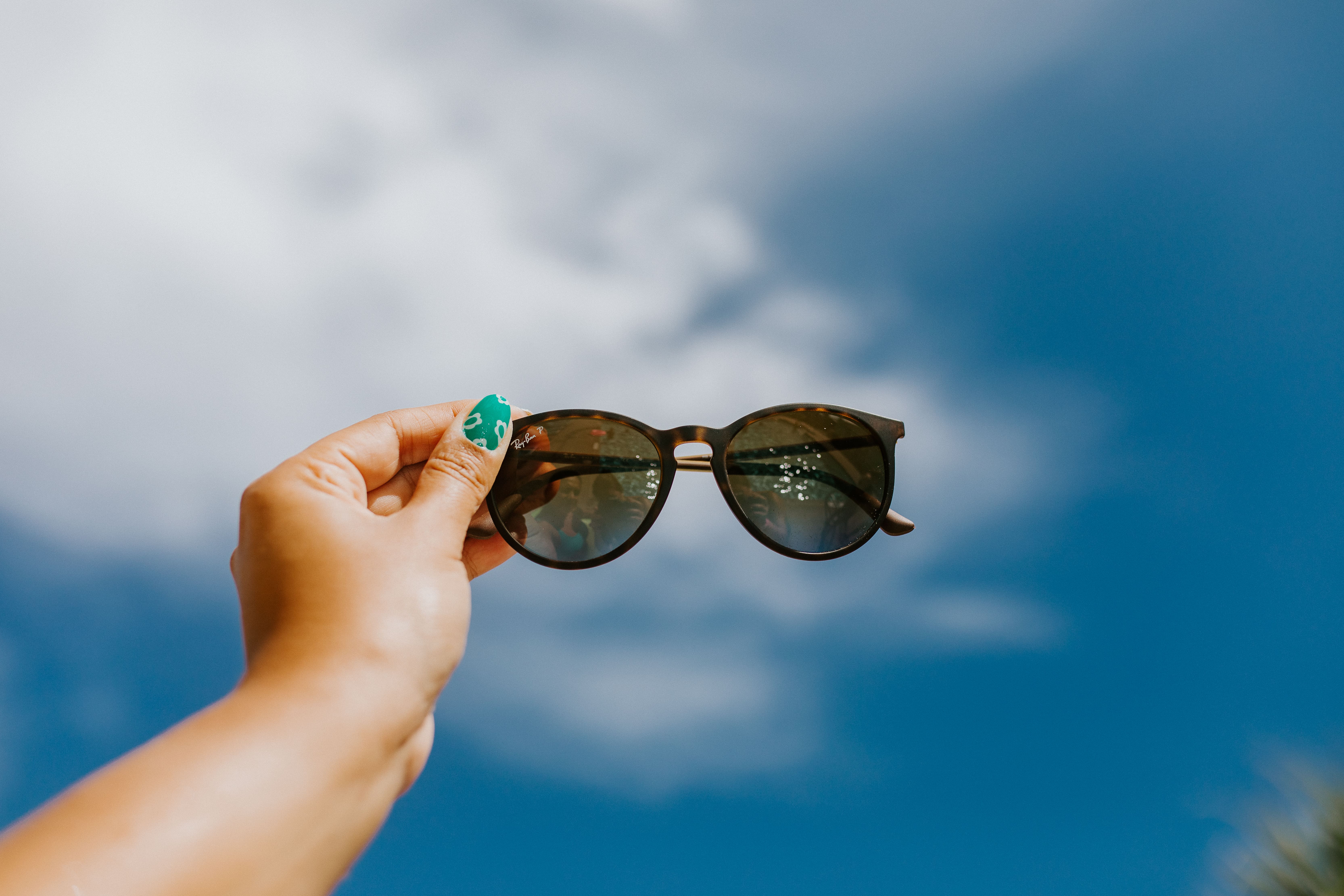 Incentive trip guests selecting designer sunglasses at a beachside gifting activation