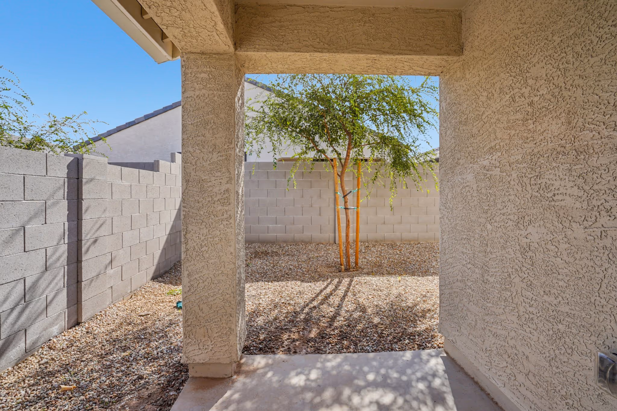 Exterior covered porch with tree