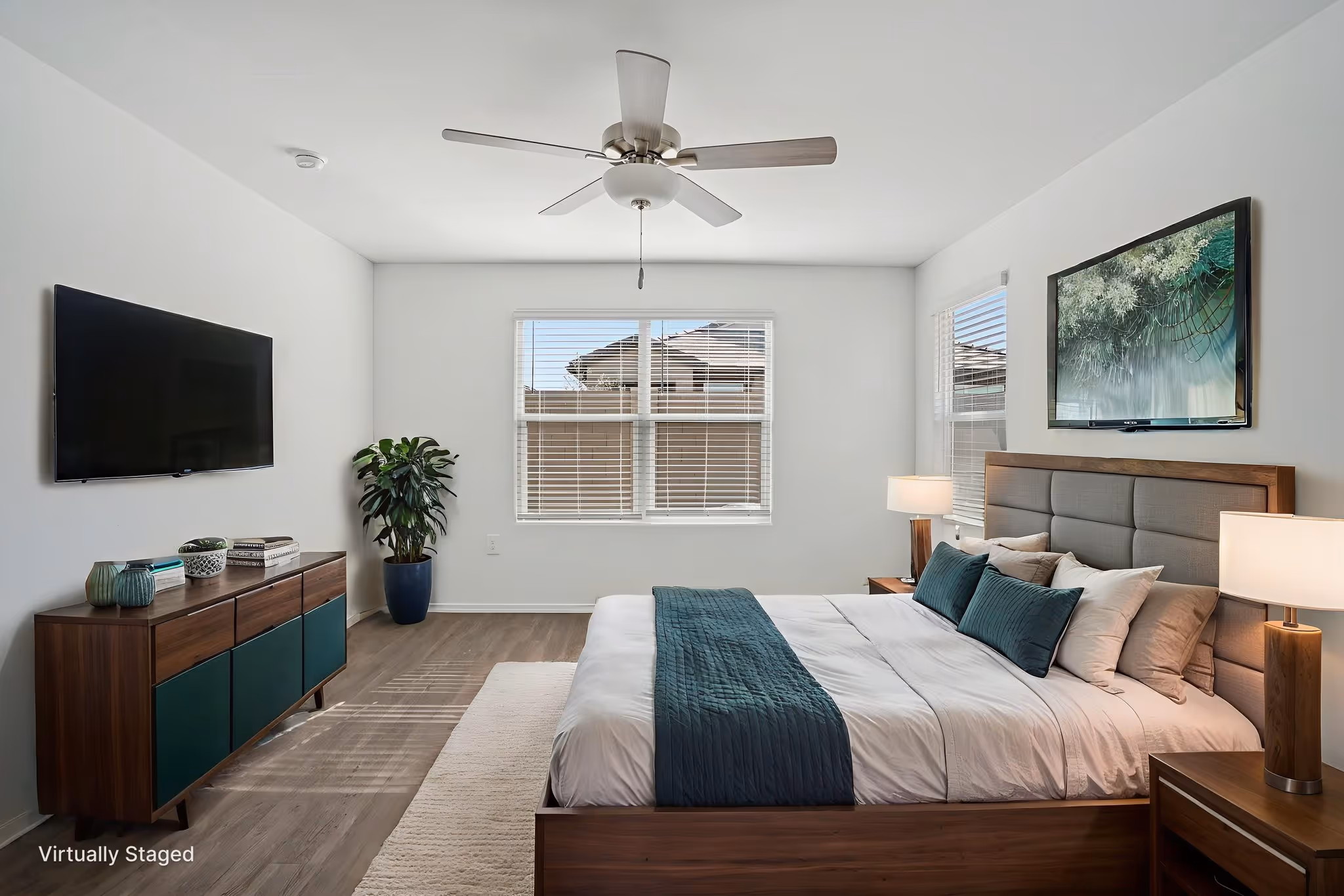Staged bedroom with bed, nightstand and television