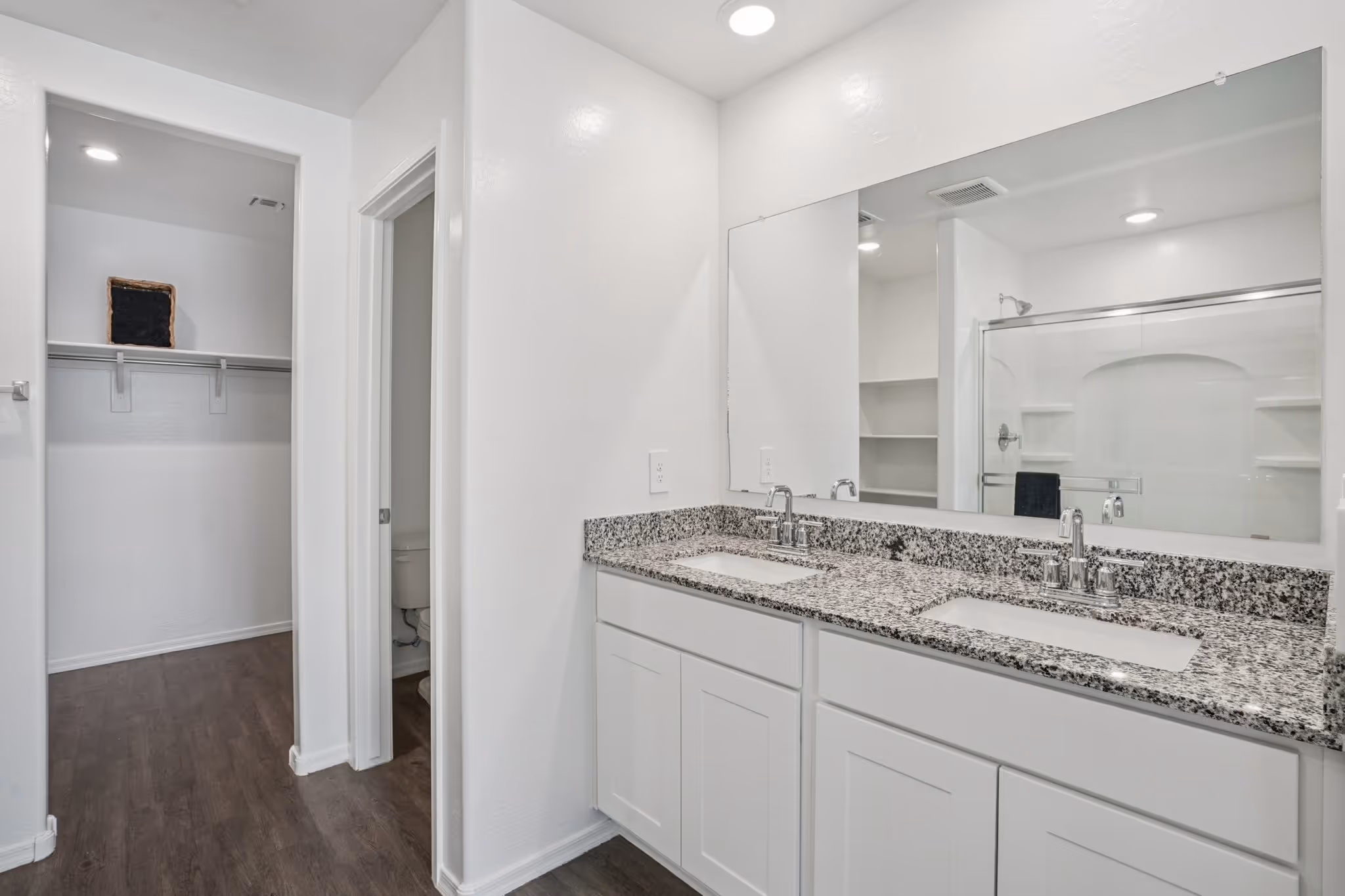 Double vanity sink bathroom leading into closet