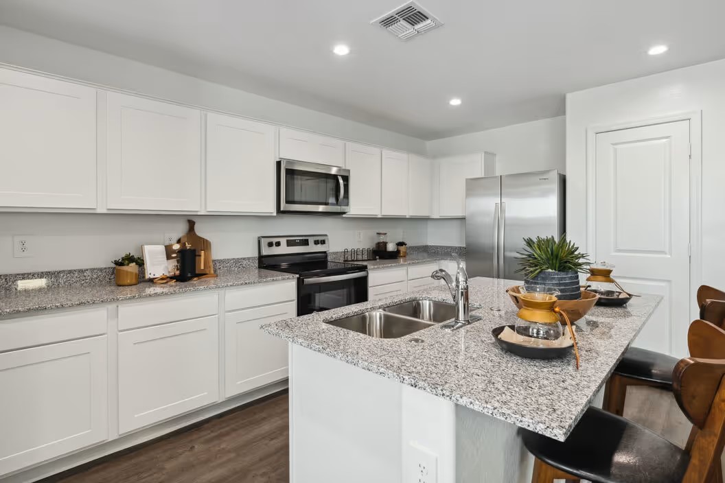 Kitchen with white cabinets and stainless steel appliances