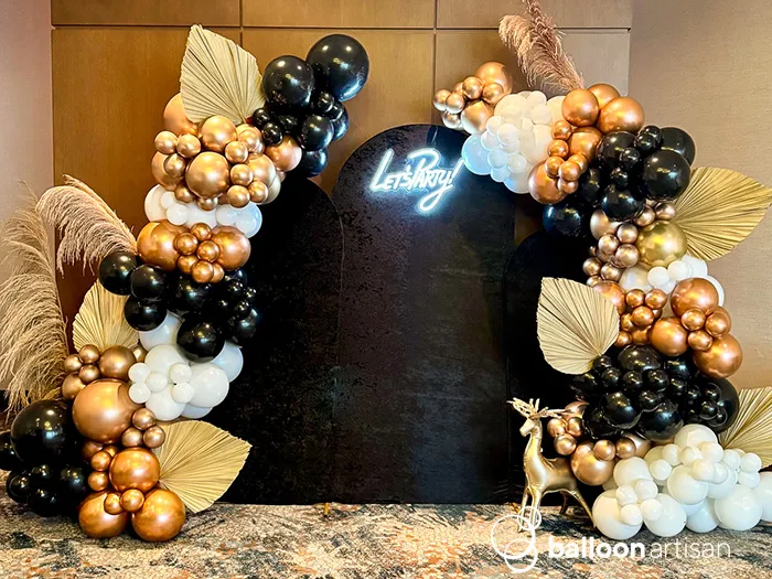 A new years holiday themed balloon backdrop for a classy and elegant themed company party is a unique balloon photo op for people to take pictures in front of.