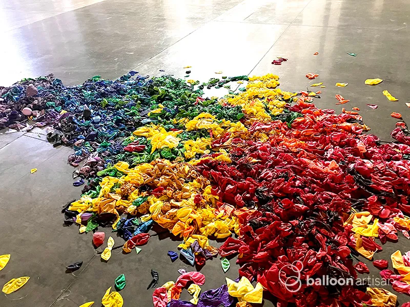 Are popped balloons environmentally friendly? Image of popped balloons on the ground.