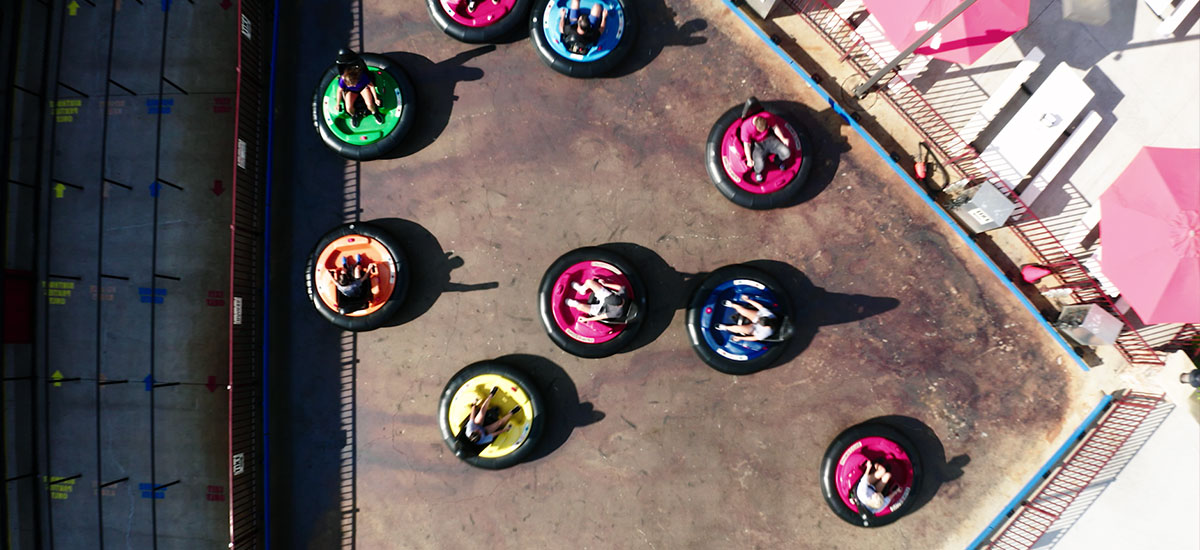 Group of friends playing bumper cars at Clubhouse Fun Center
