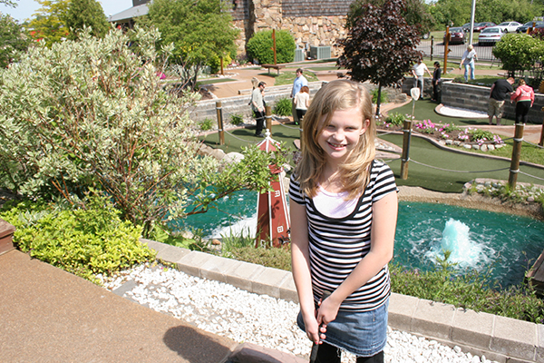 Girl playing mini golf in Henrietta