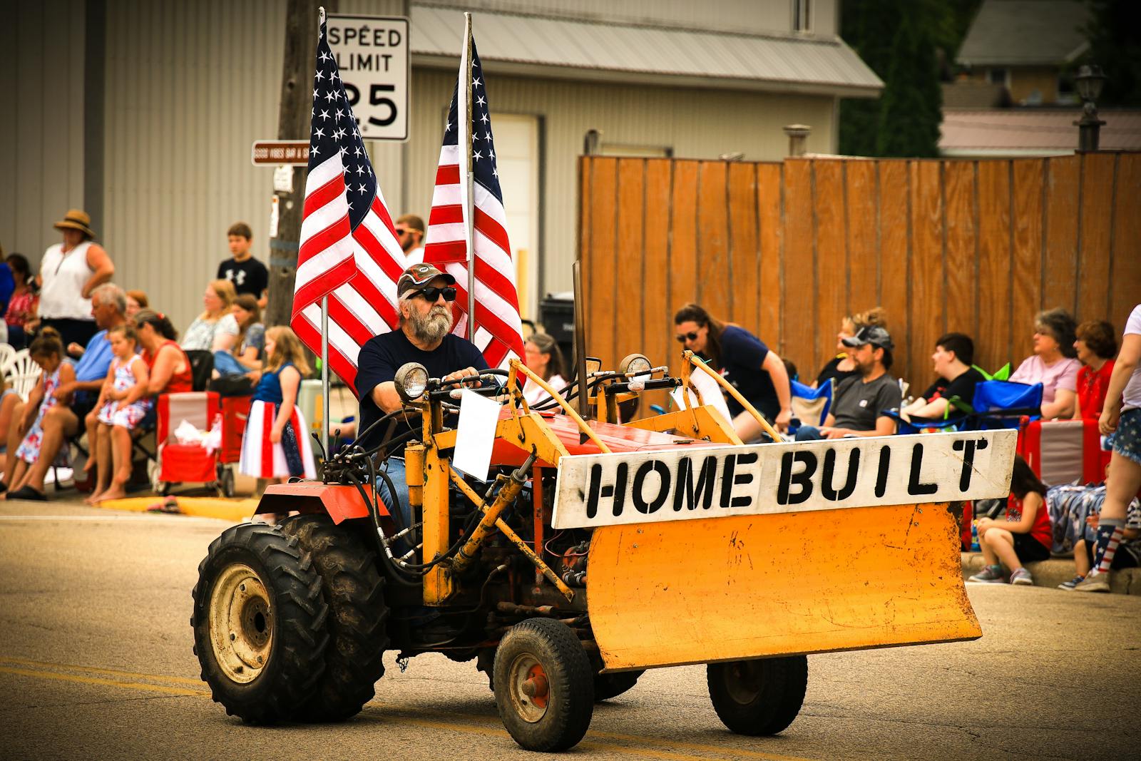 Small-town Fourth of July community parade decorated with American flags