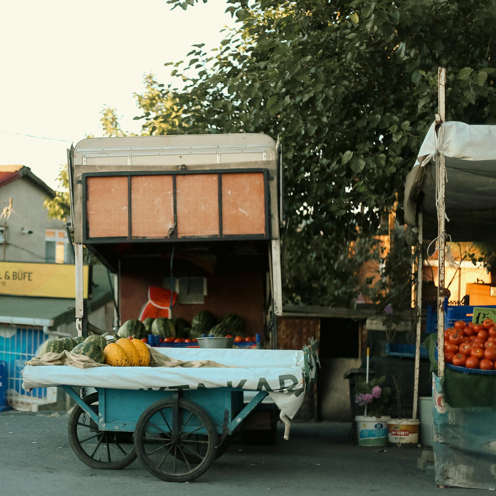 Outdoor market stalls with fresh produce and goods at a makers market