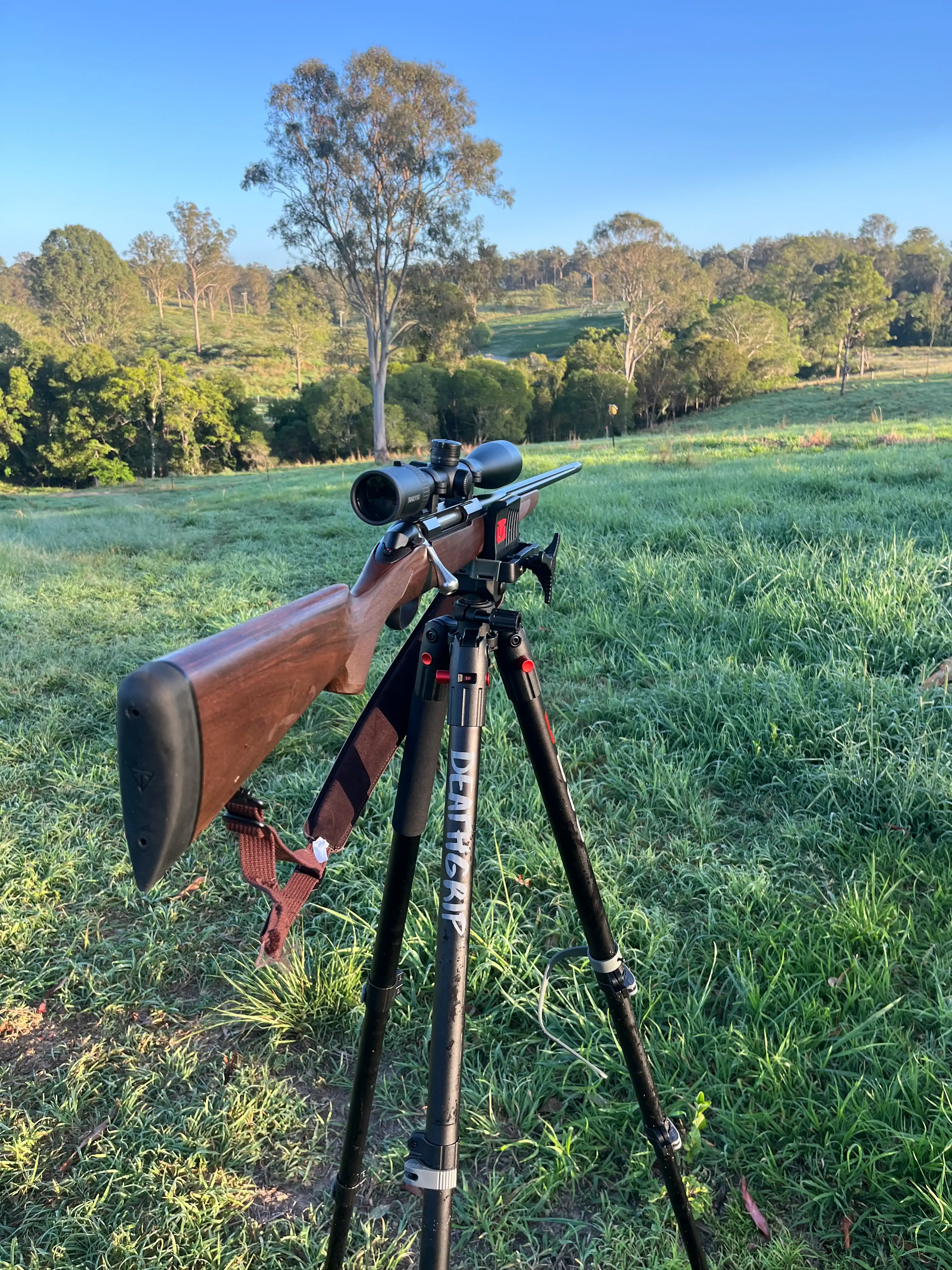 image of a farmer operating a drone over agricultural land