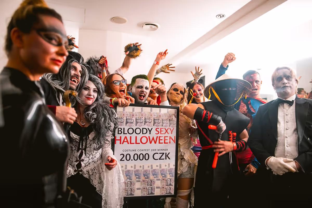 Halloween costume contest winners holding their winnings