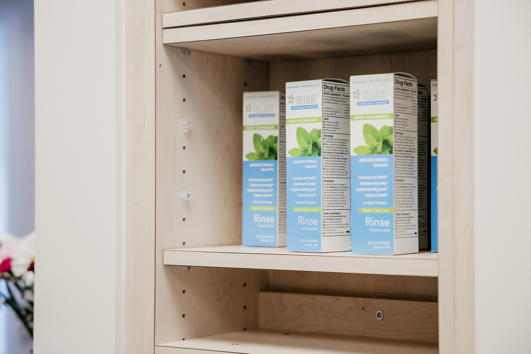 Shelf with multiple boxes of Stellalife Spearmint antimicrobial rinse displayed.