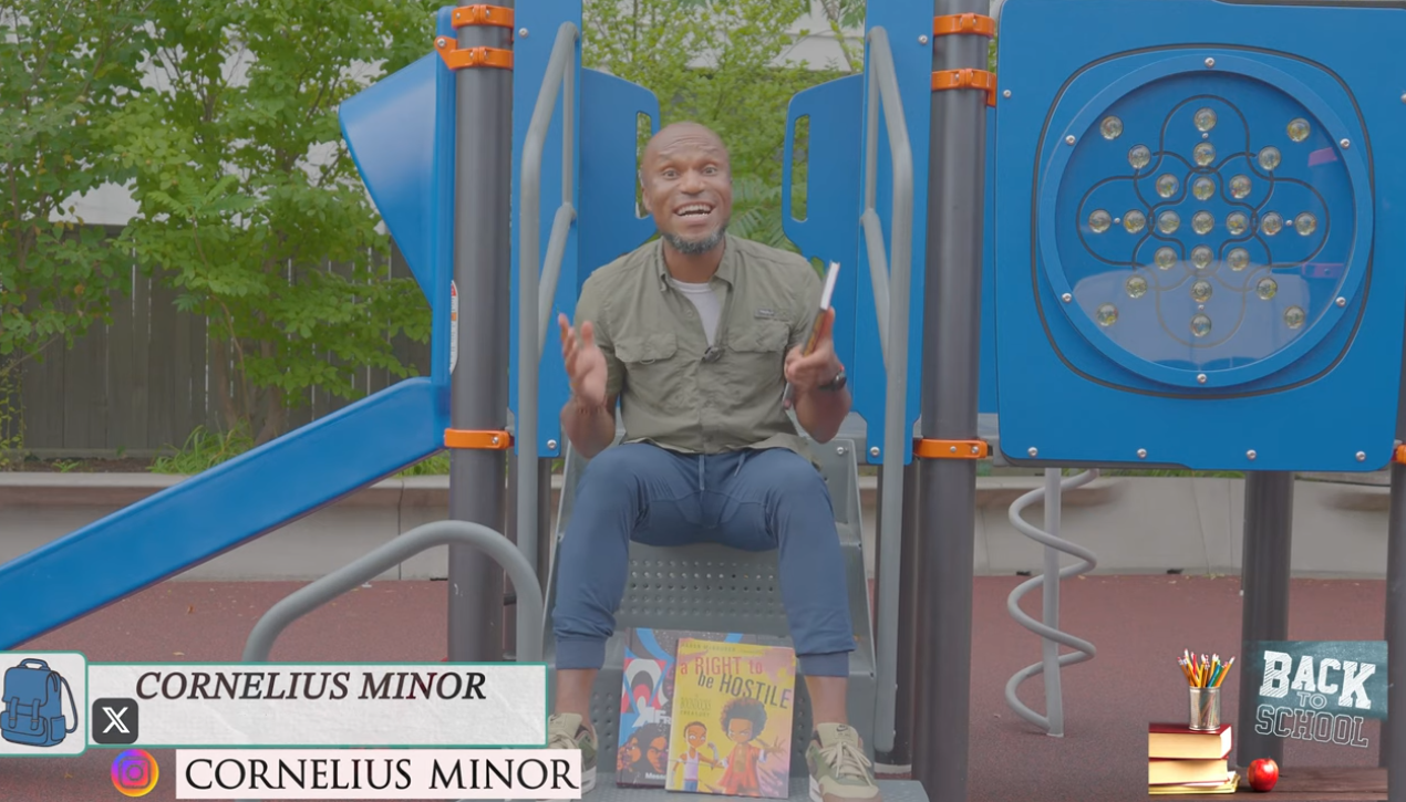 Corn sitting on a playground with books