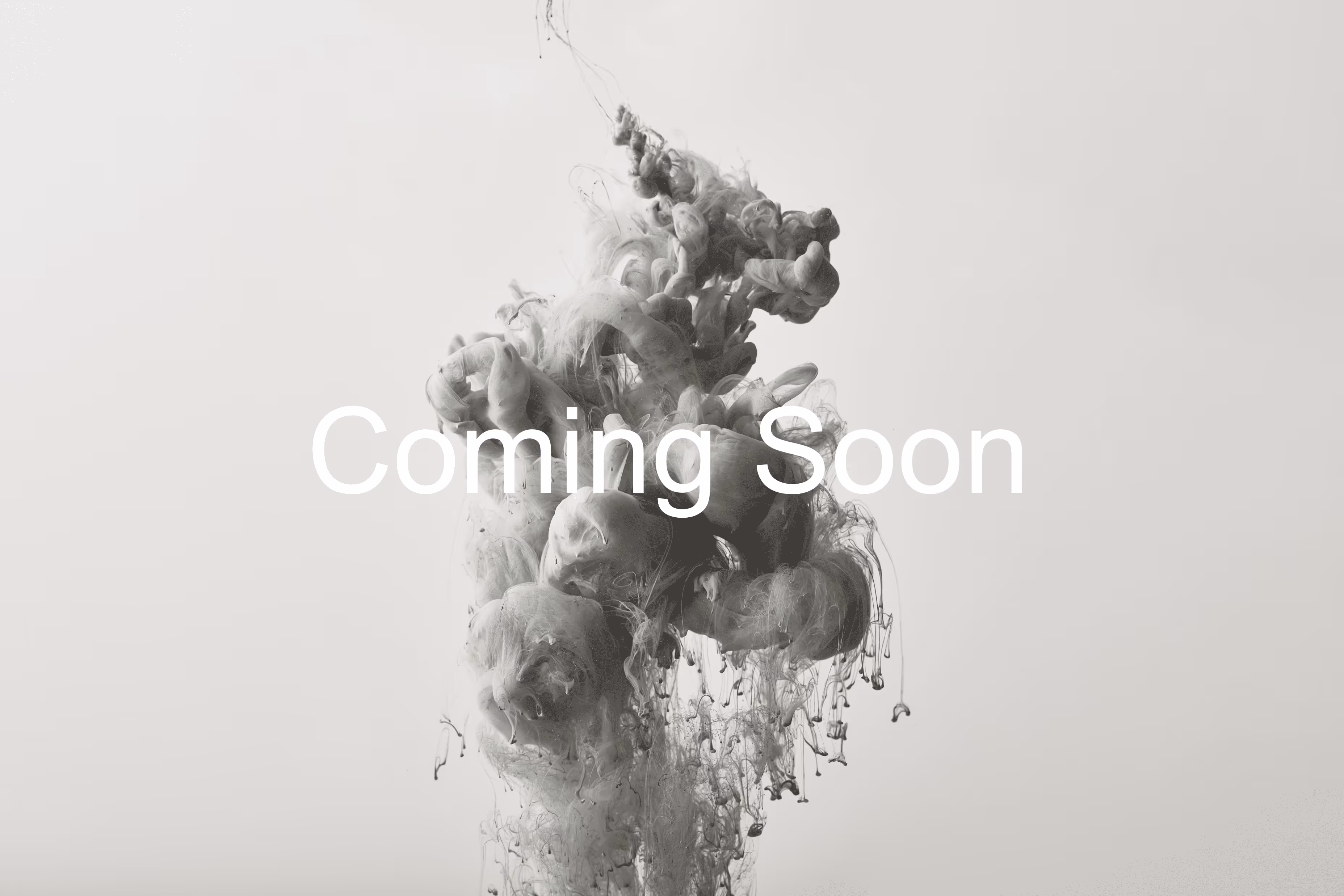 Gray ink swirling in water with 'Coming Soon' text overlay on a light background.