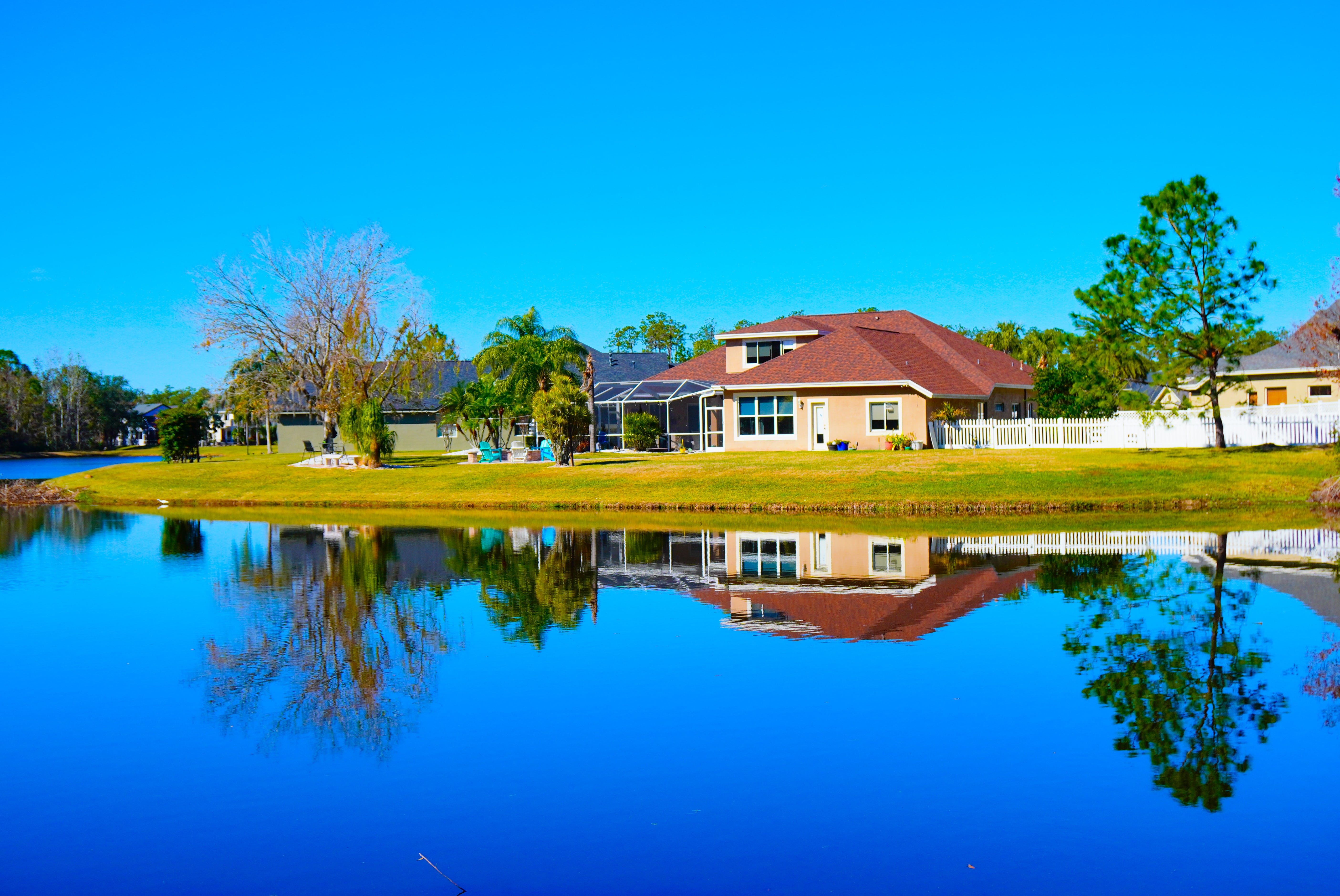 a house next to a body of water