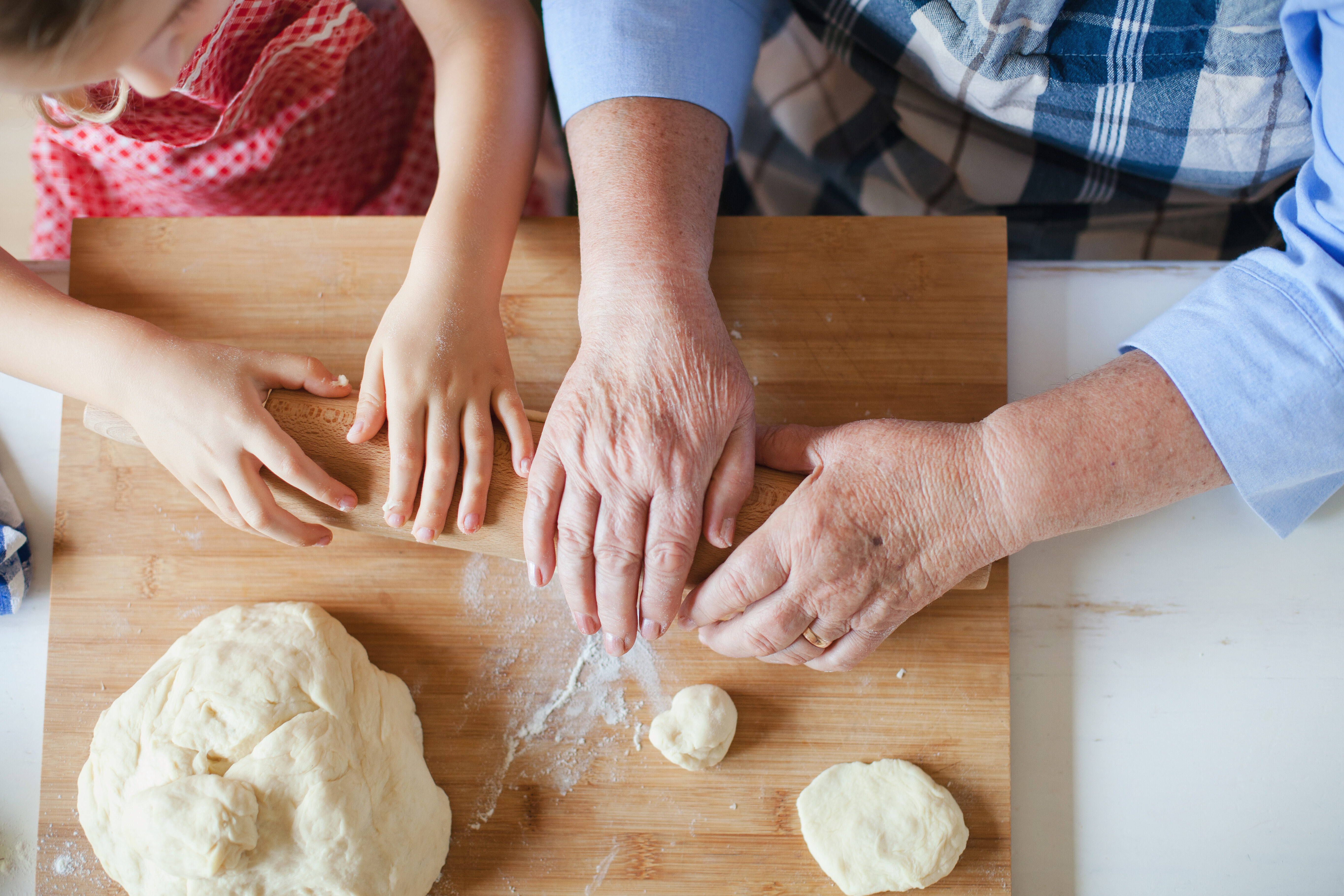 senior and child pressing dough stock image
