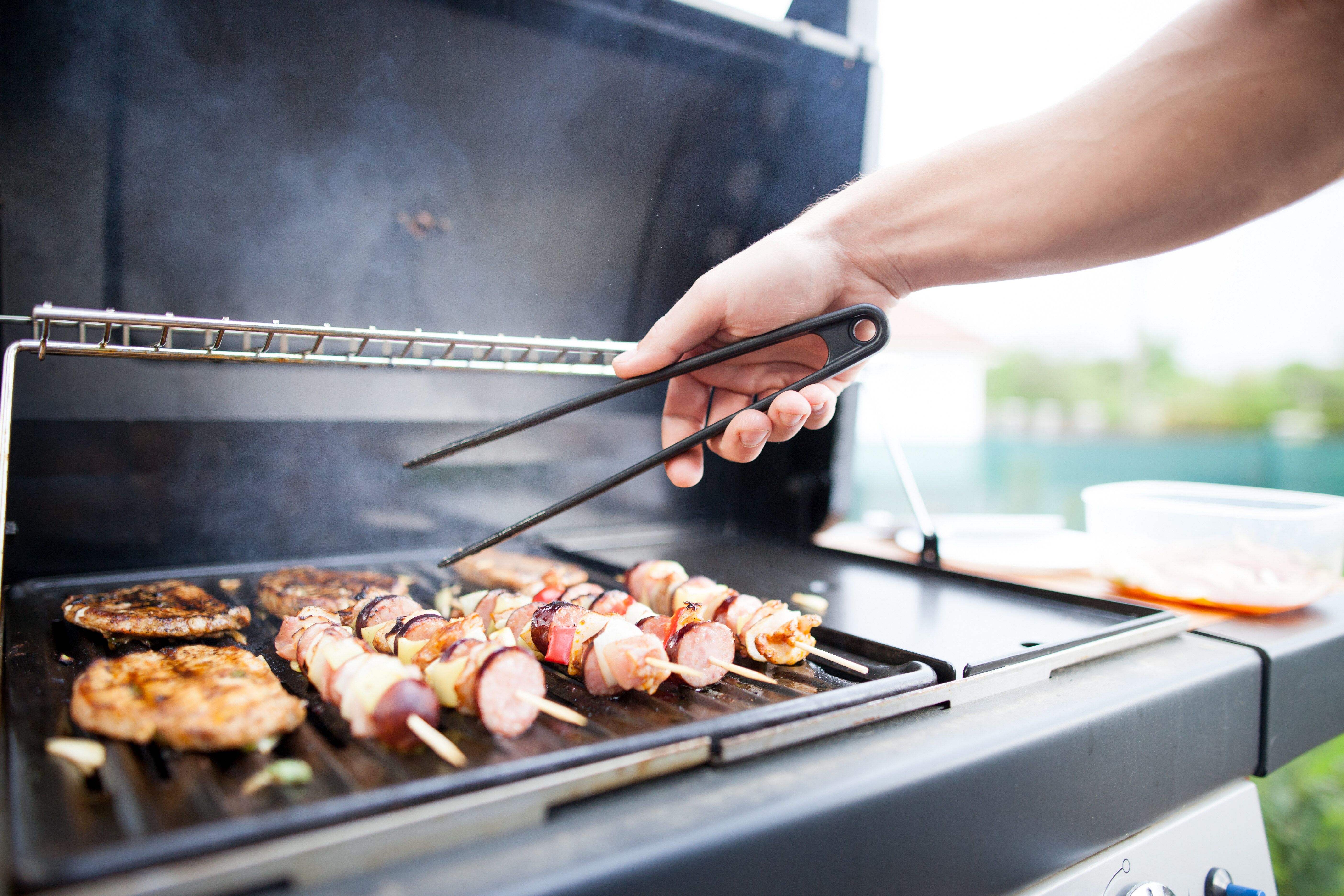 man grilling food on grill outside stock image