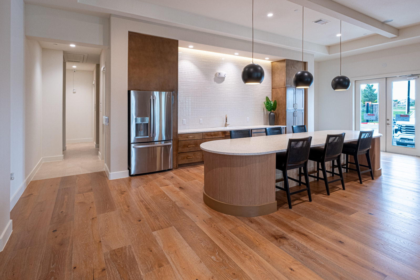 Clubhouse kitchen with bar and stools 